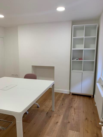Minimalist meeting room in Mimosa House with spacious table for collaborative brainstorming.