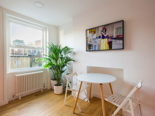Bright office meeting space with round table, ideal for brainstorming and casual discussions.