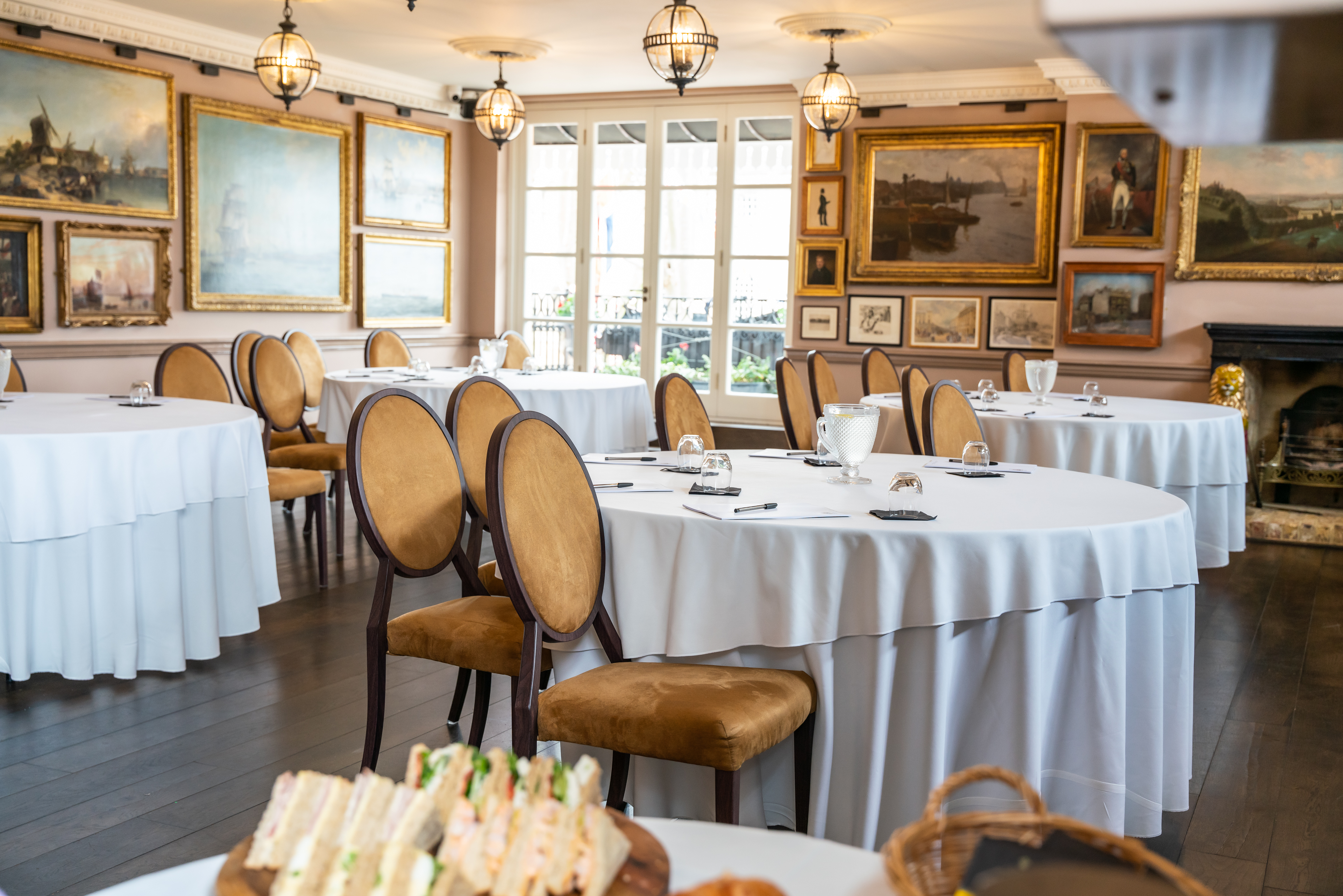 Hardy Suite at Trafalgar Tavern: elegant meeting space with round tables for networking events.