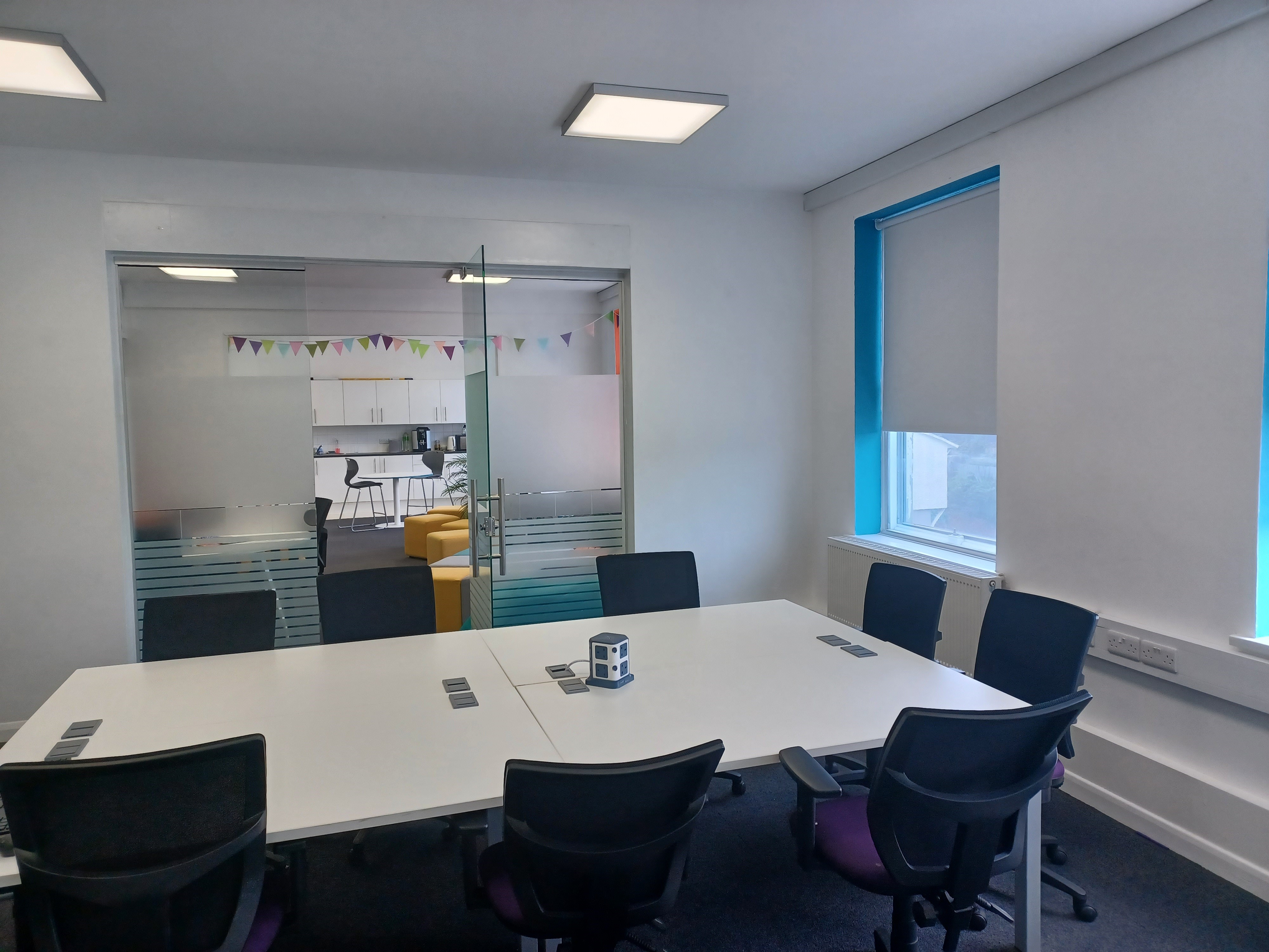 Modern meeting room at BSC Brighton with spacious table, ideal for team discussions.