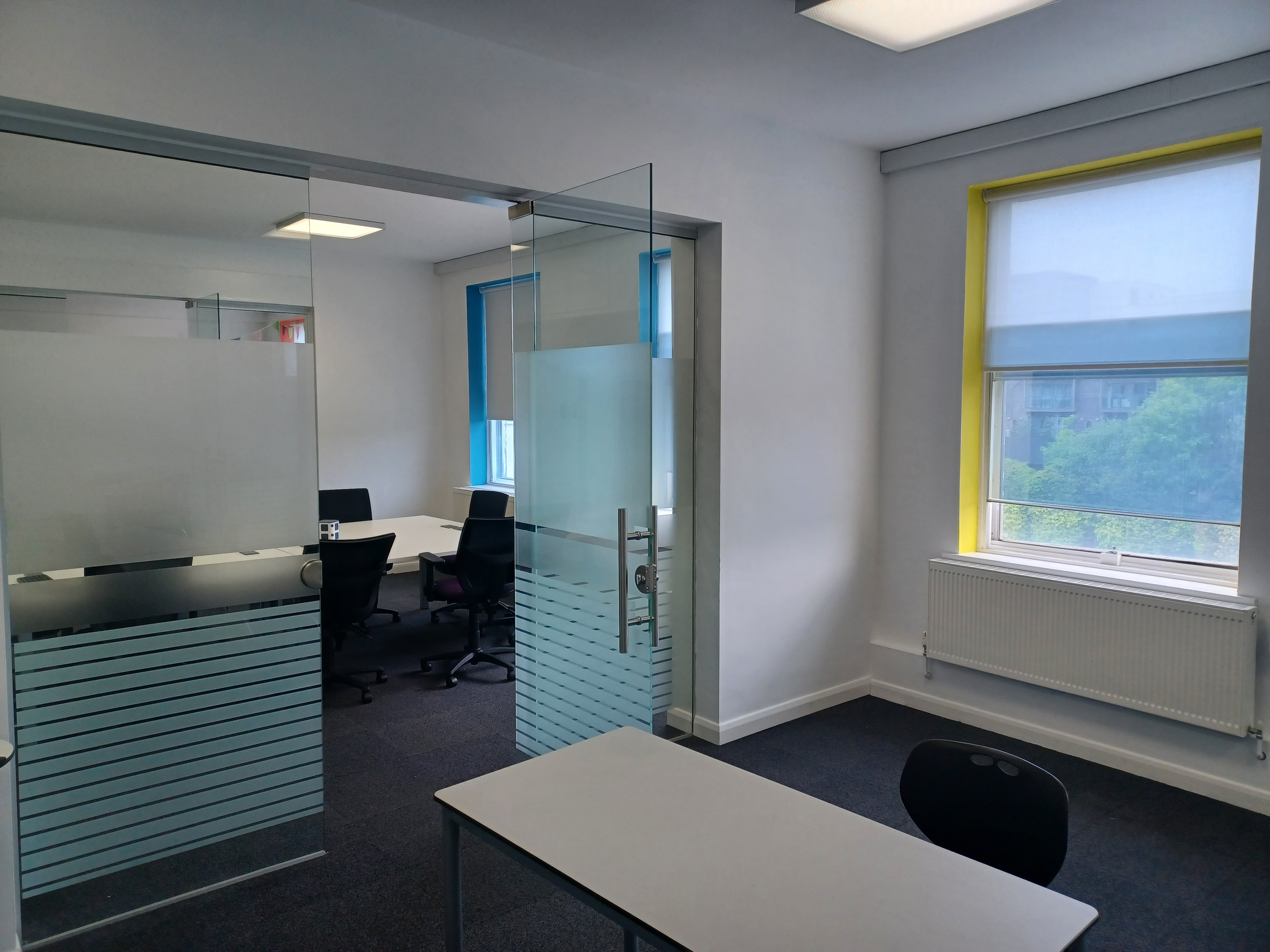 Modern meeting space at BSC Brighton with glass walls for collaboration and productivity.