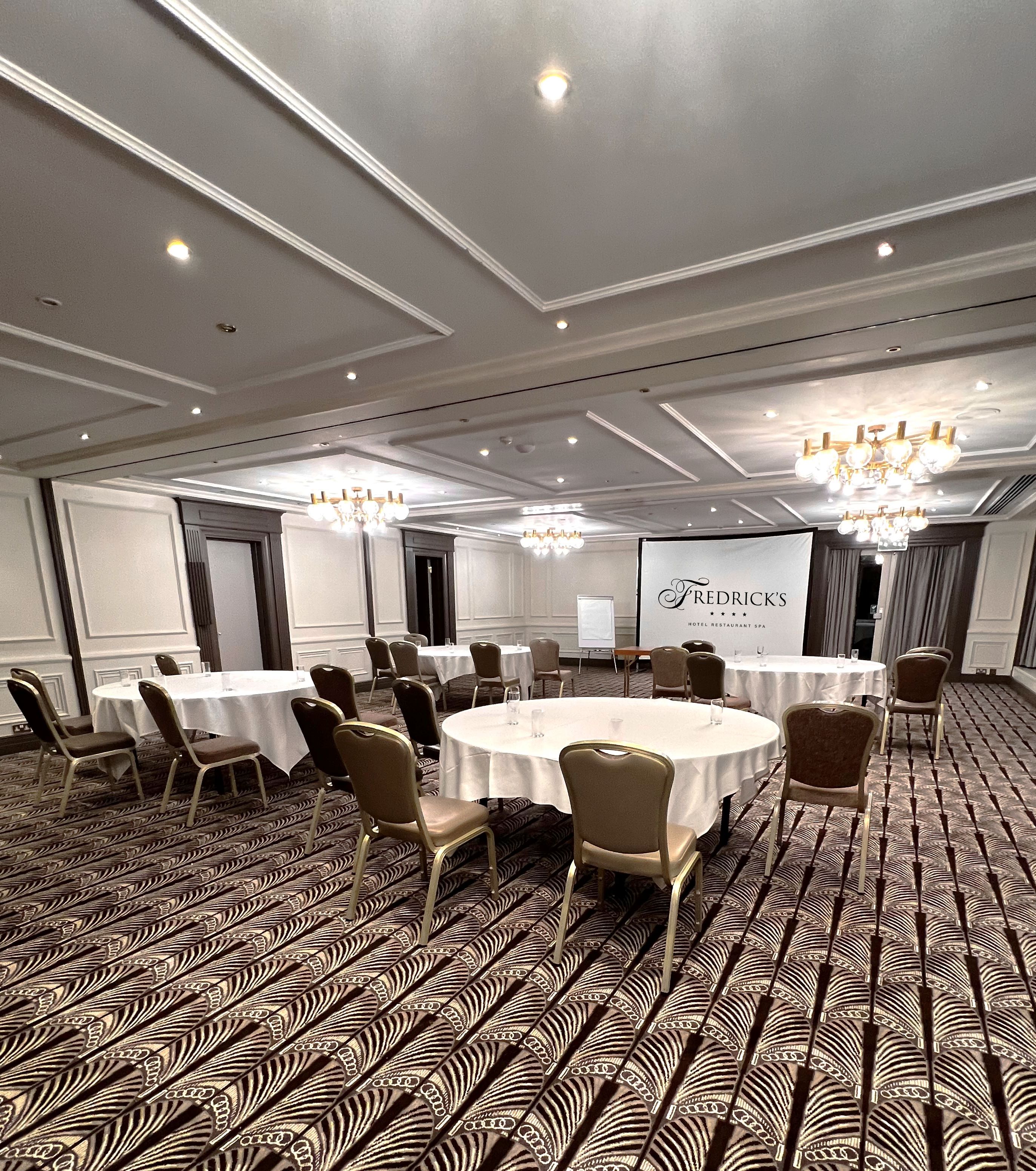 Fredrick's Suite meeting room with round tables, ideal for corporate events and seminars.