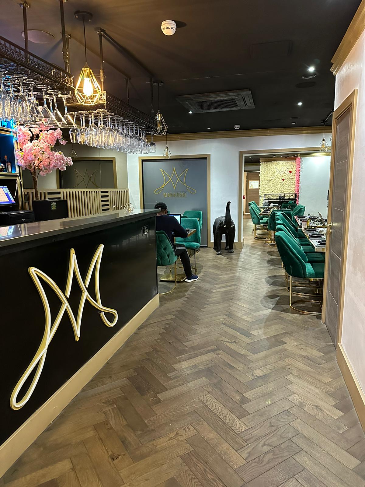 Stylish Maharani Lounge with elegant green seating for upscale events and private dining.