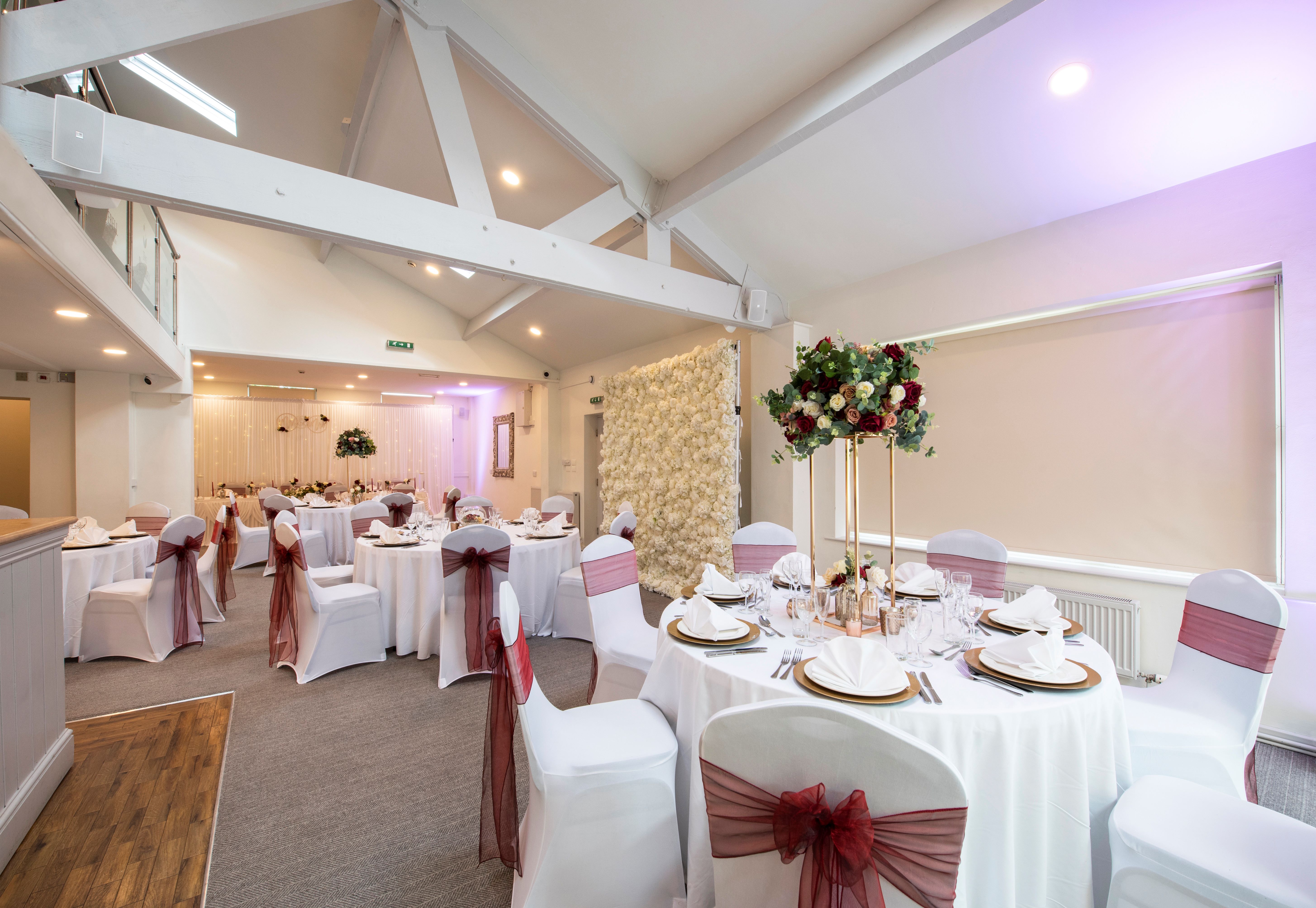 Elegant Bluebell Suite event space with round tables, perfect for weddings and gatherings.