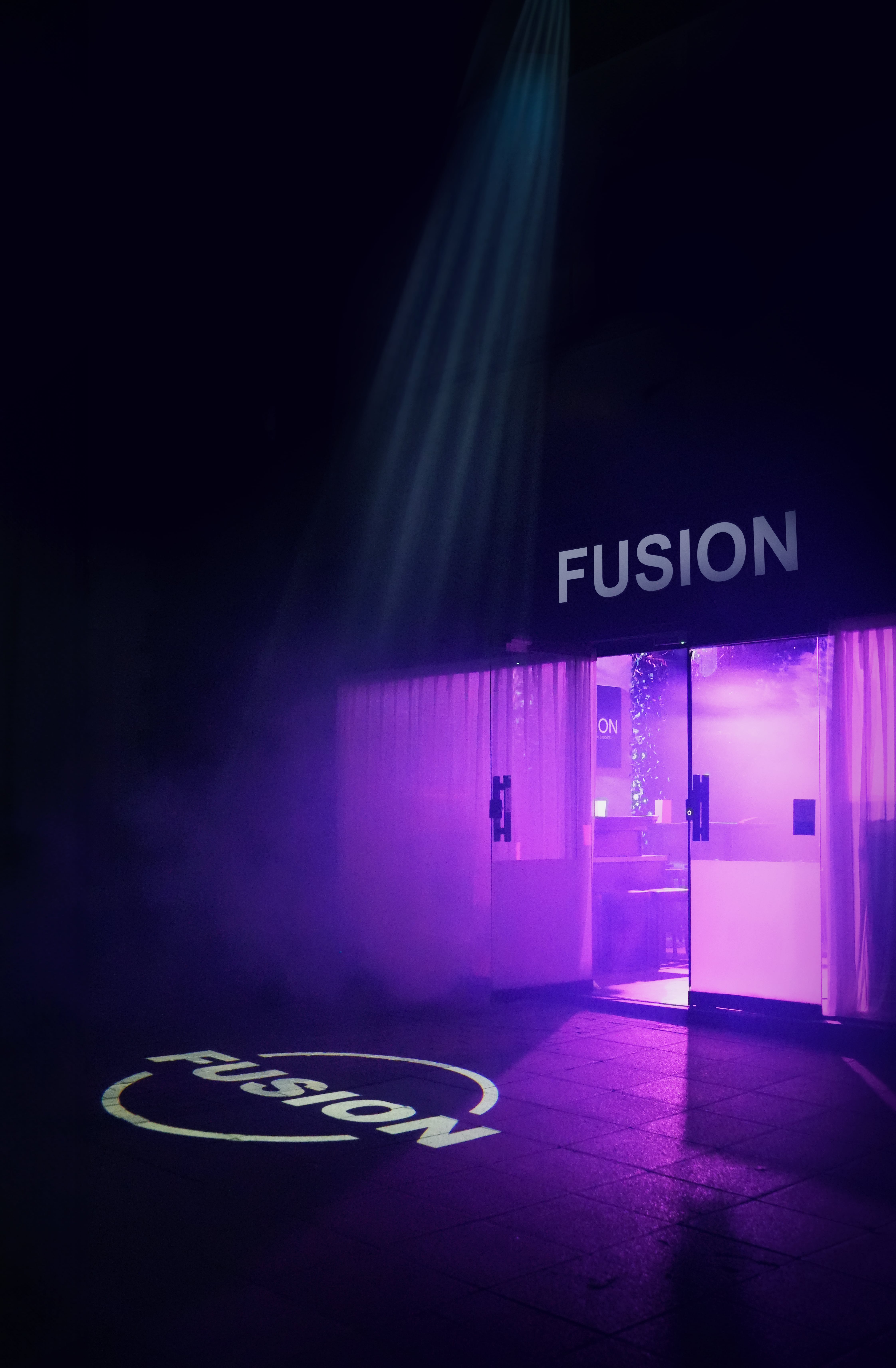 Sleek entrance of Fusion Creative Studios event space with vibrant purple lighting.