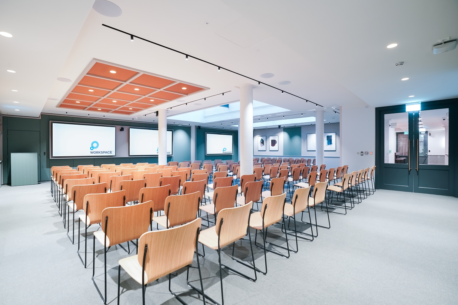 Conference room setup with wooden chairs and screens at Salisbury House event space.