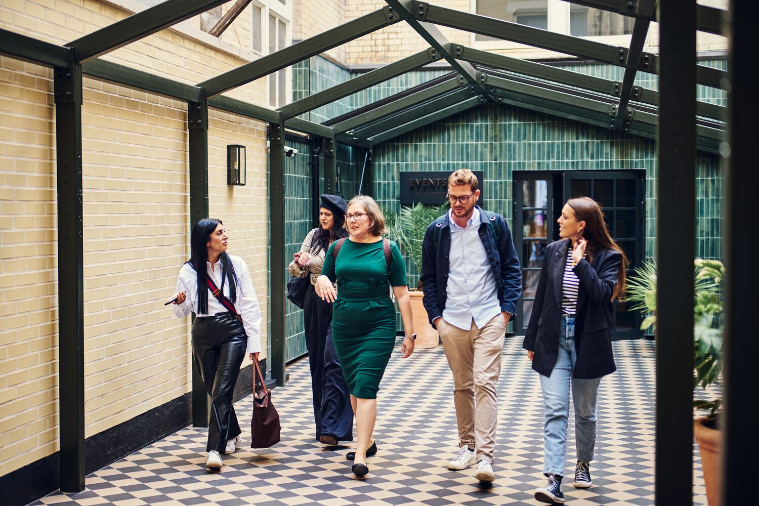Professionals networking in a stylish corridor at Salisbury House event space.