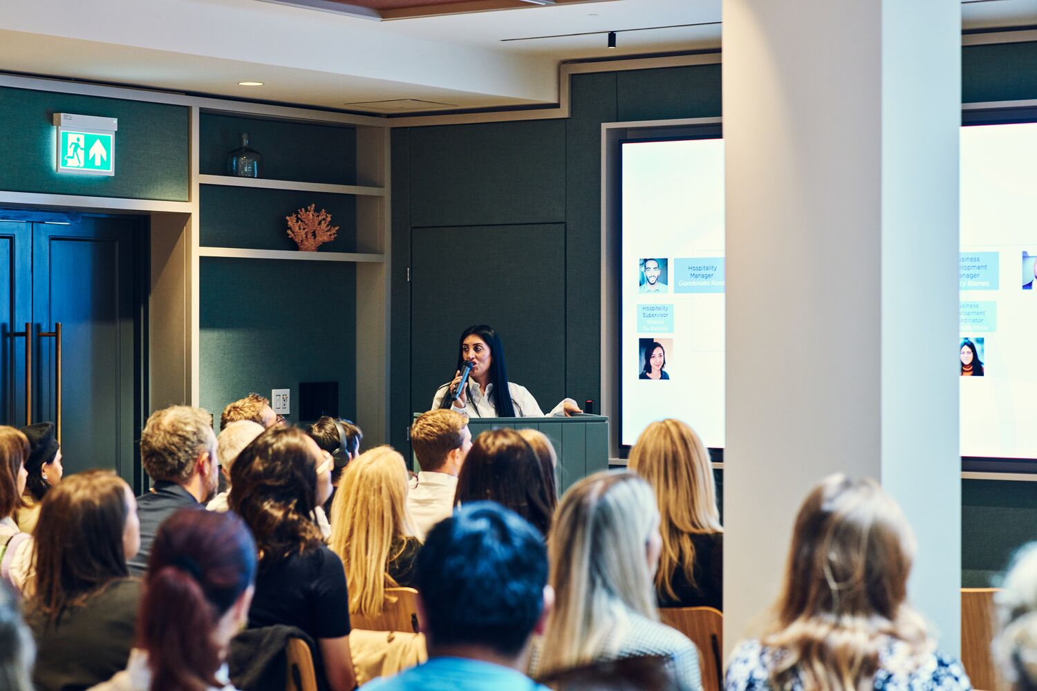 Professional speaker engaging audience in modern Salisbury House event space.