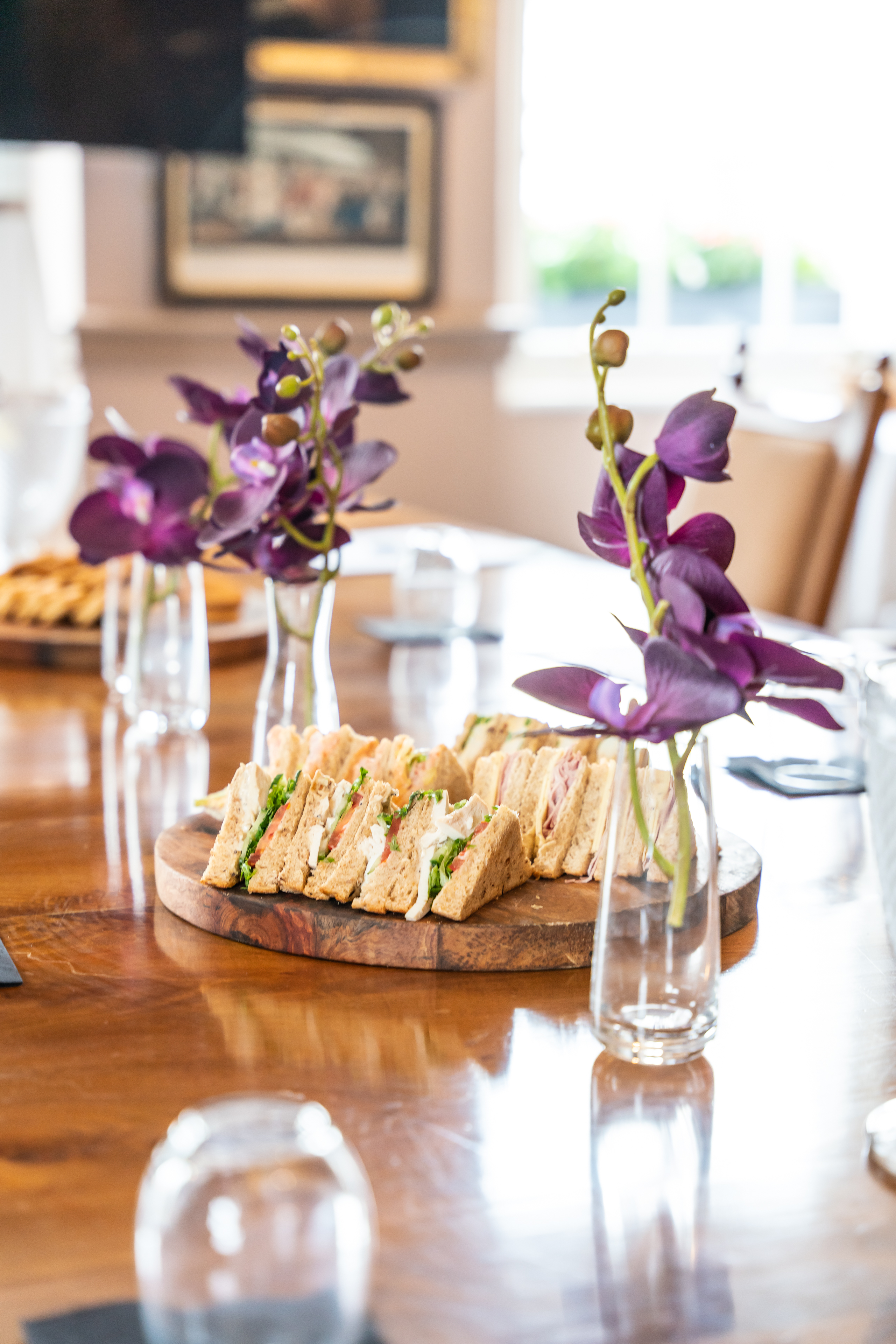 Elegant sandwich platter with floral decor at Pickle Room, perfect for events and meetings.