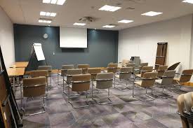 Meeting room in Leonardo Hotel Exeter, featuring a central screen for presentations.
