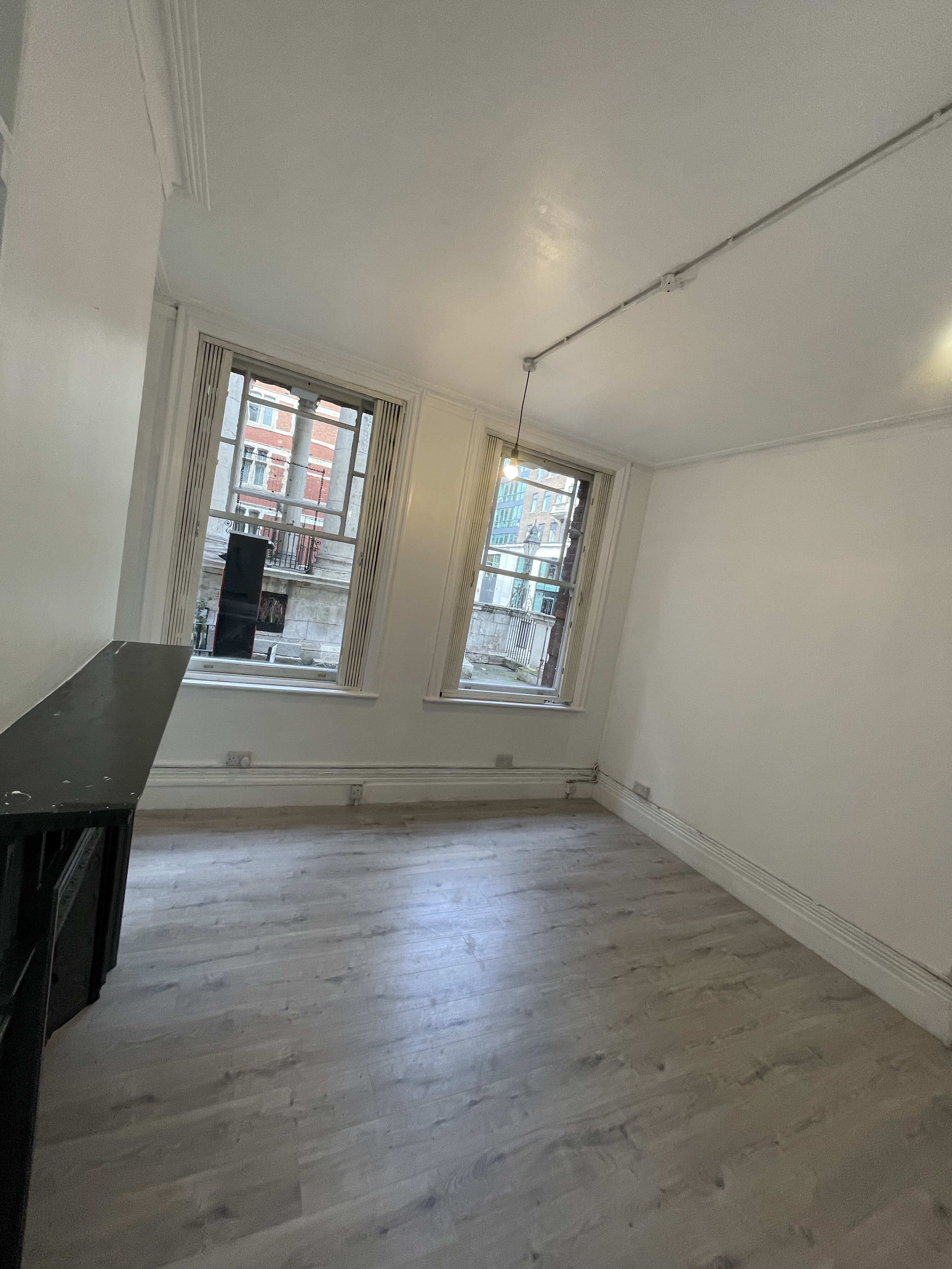 Bright, minimalist event space with large windows for workshops and gatherings.