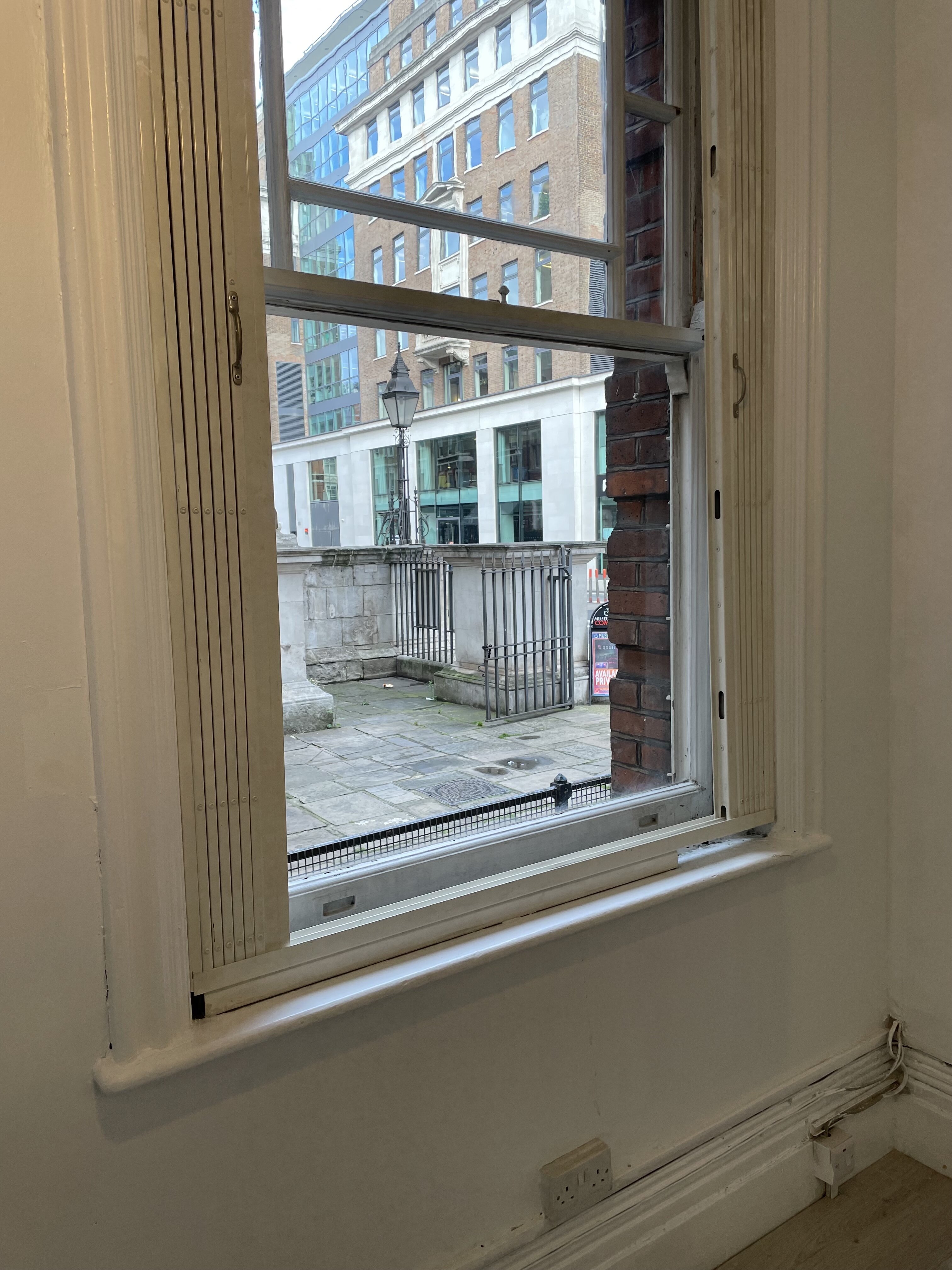 Window view of Saras Space, blending modern and historical design for events.