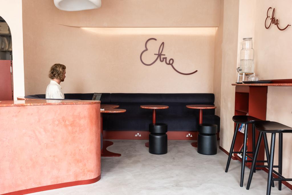 Modern minimalist meeting space with booth seating for creative workshops and gatherings.