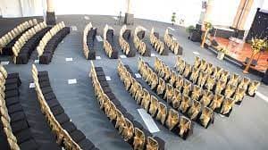 Elegant conference setup at The Rock Tower with black and gold decor, ideal for networking.