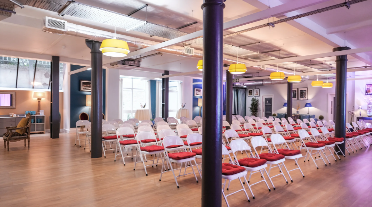 Event space at La Galeria with stylish red-cushioned chairs for meetings and presentations.