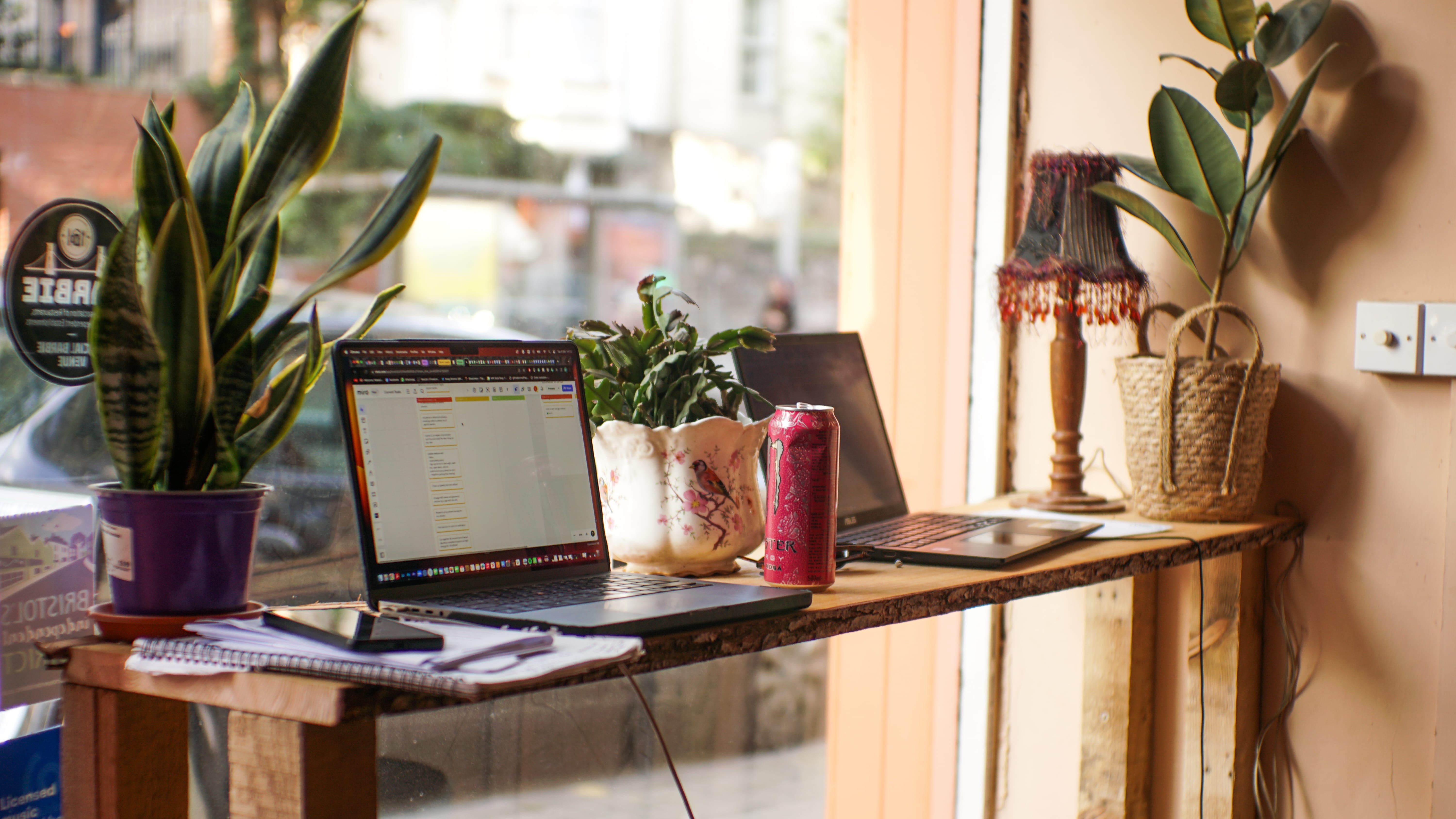 Cozy Cloak Cafe/Bar workspace with laptops, ideal for remote meetings and events.