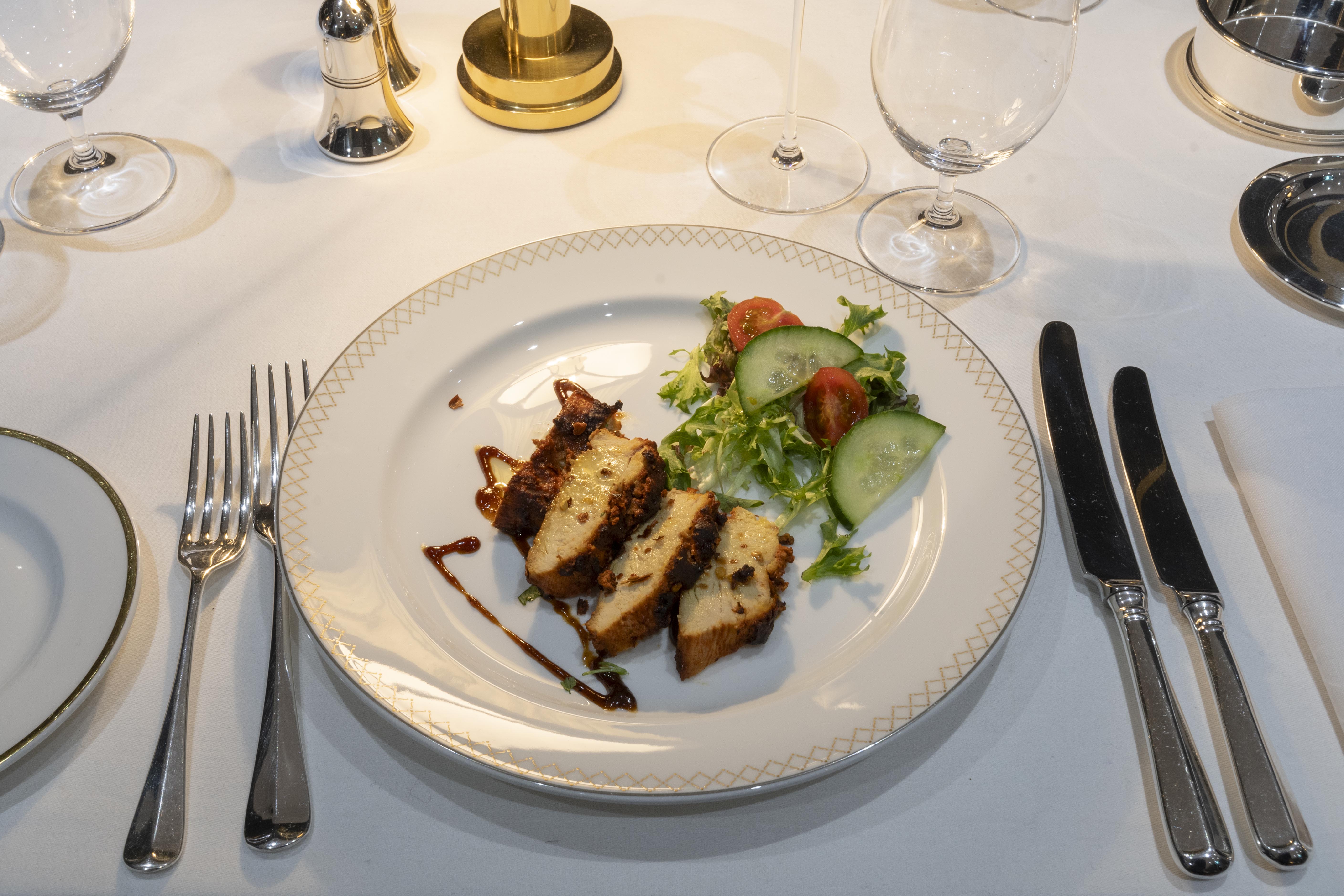 Elegant dining table with grilled chicken for corporate dinners in Jamuna restaurant.