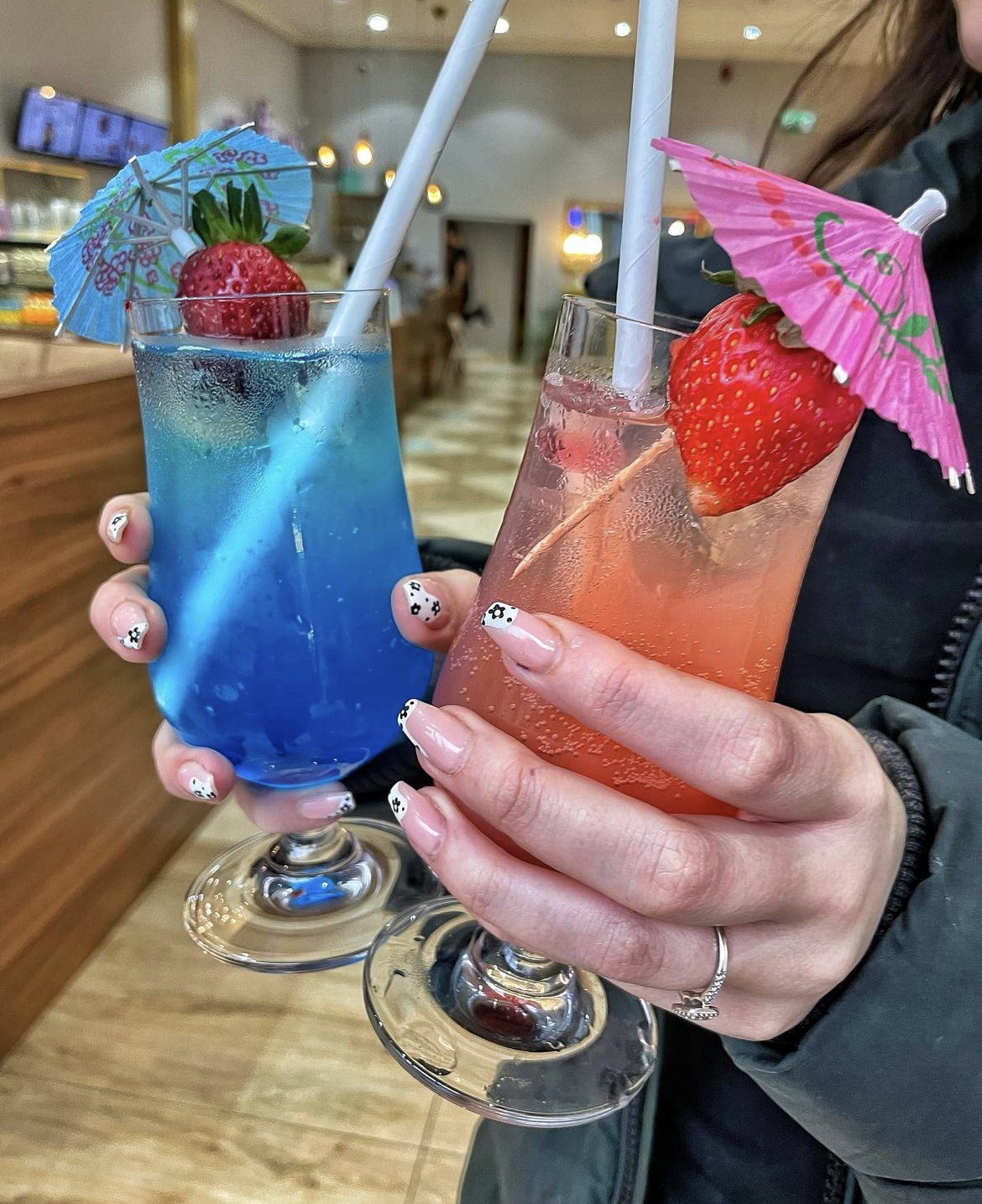 Vibrant blue and pink cocktails with fruit garnishes for festive events and gatherings.