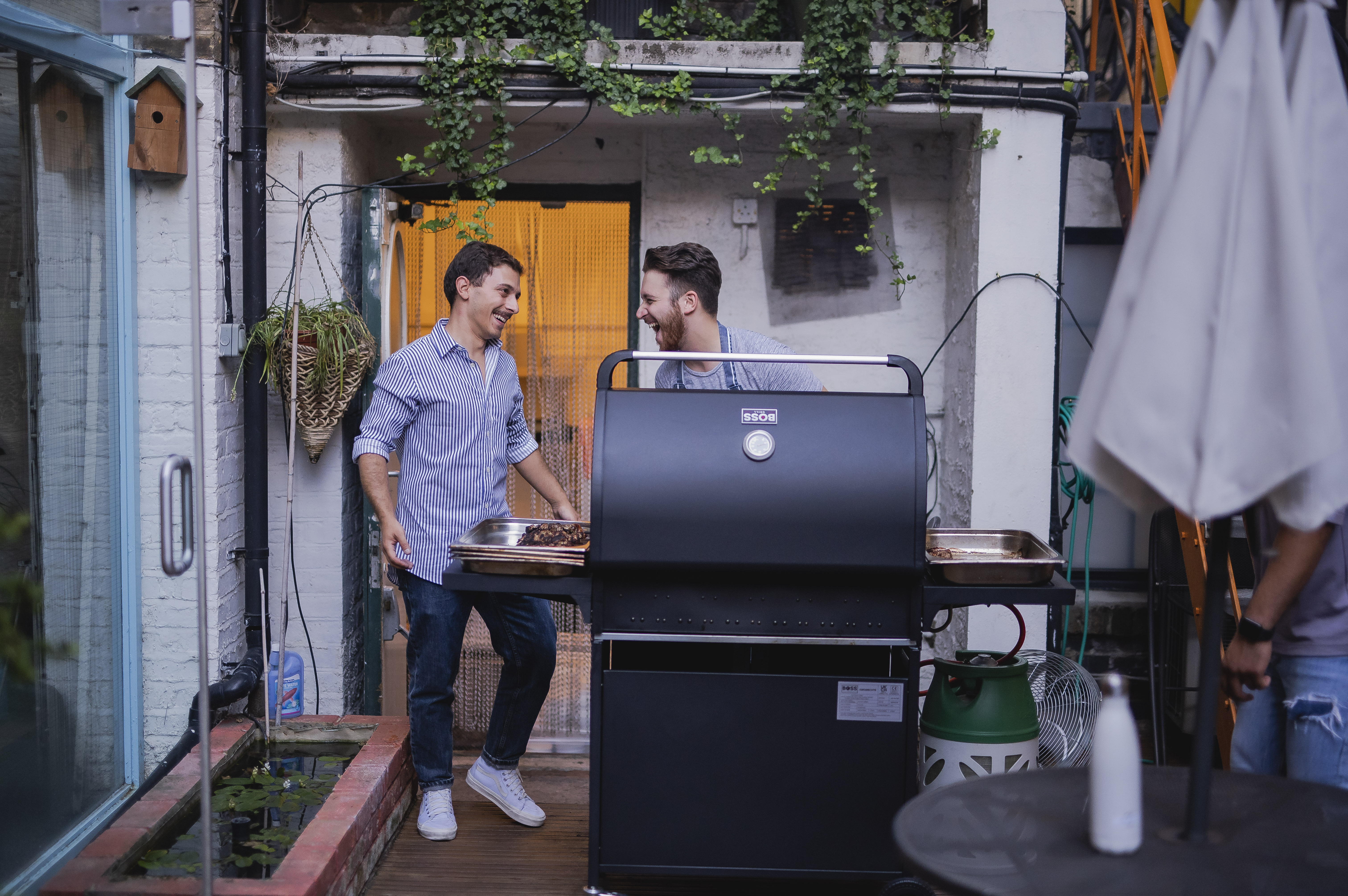 Casual outdoor team-building event at Wallacespace with grill and greenery.