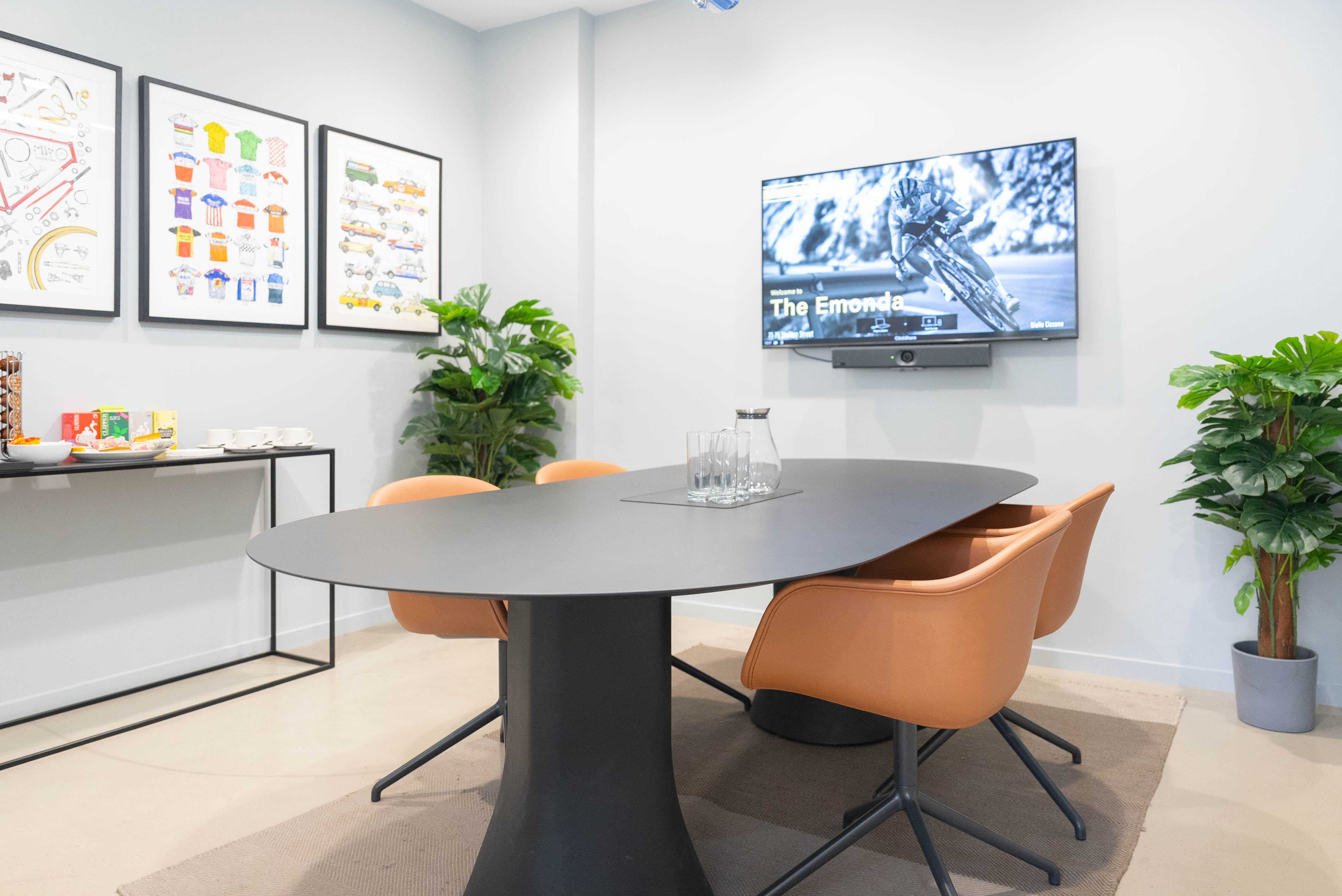 Modern meeting room with oval table, ideal for collaboration and presentations.