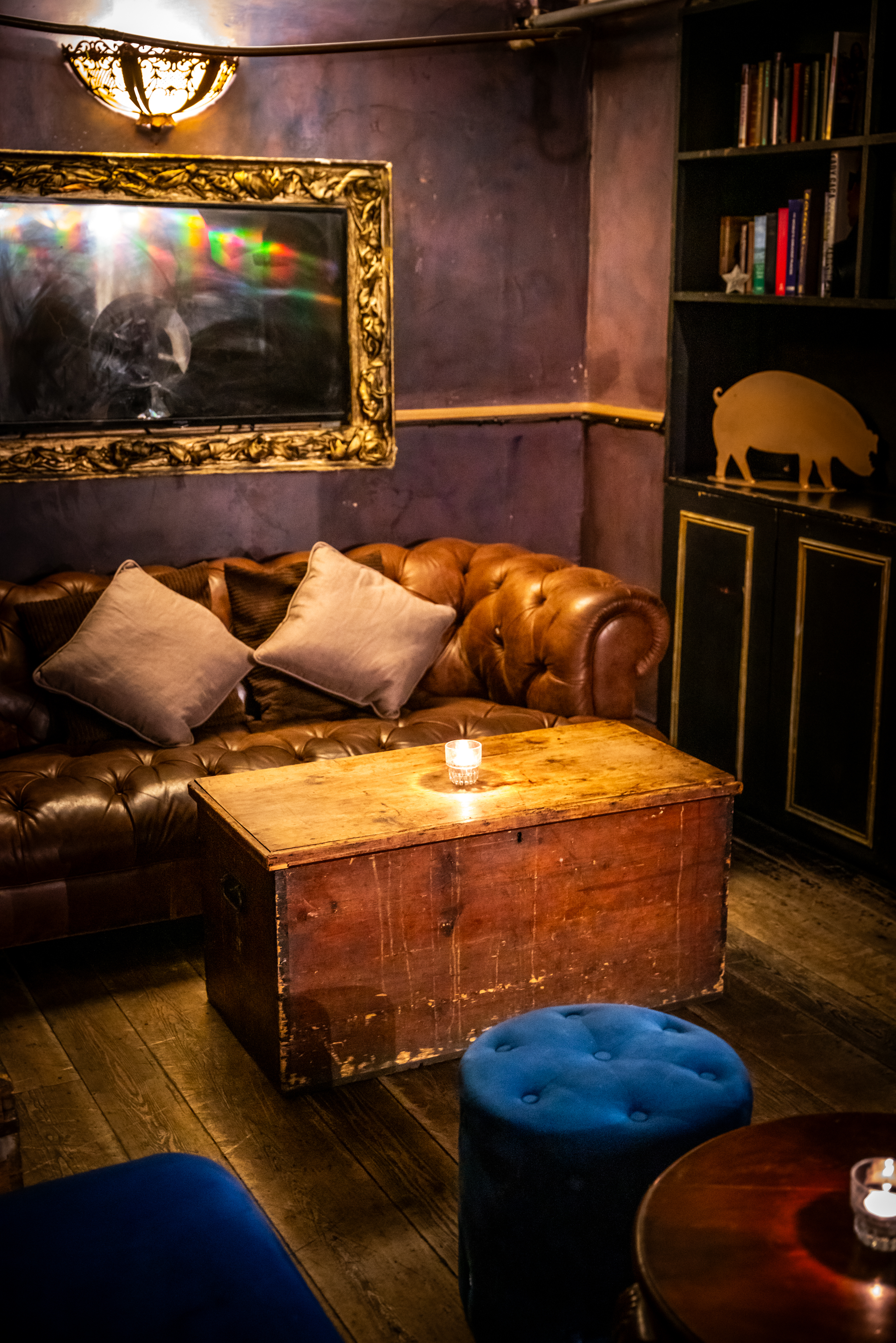 Cozy lounge area with leather sofa for private hire events at The Lucky Pig.