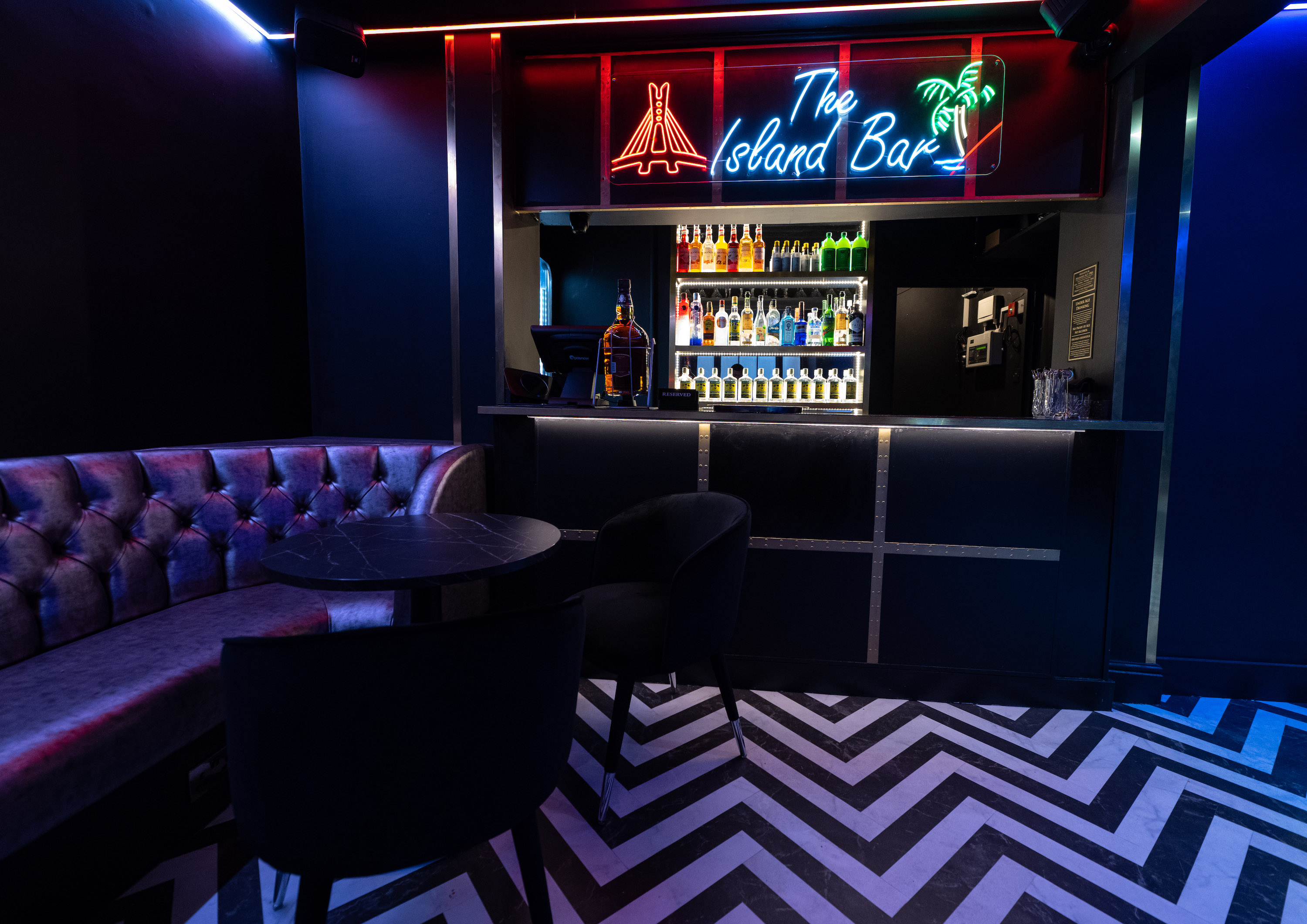 Main Lounge at Enish Restaurant, stylish bar with neon decor for networking events.