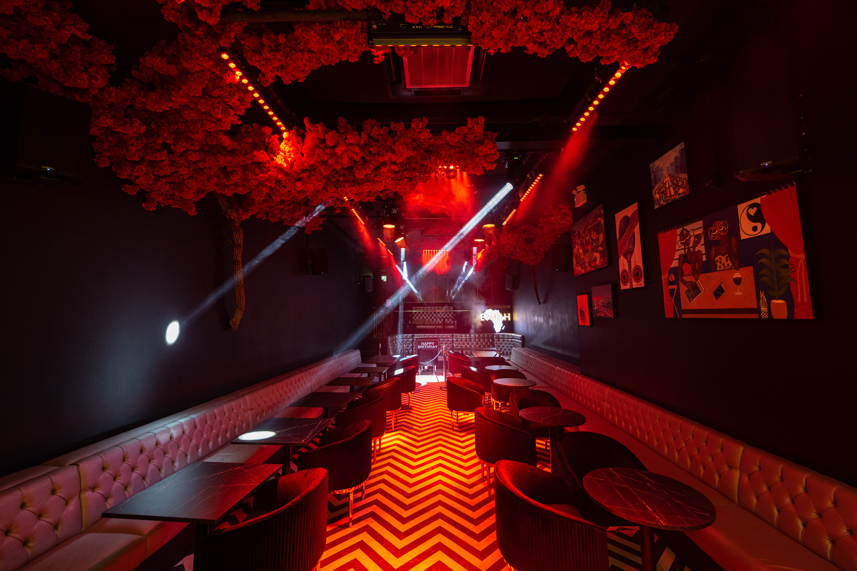Main Lounge at Enish Restaurant, vibrant red lighting for events and gatherings.
