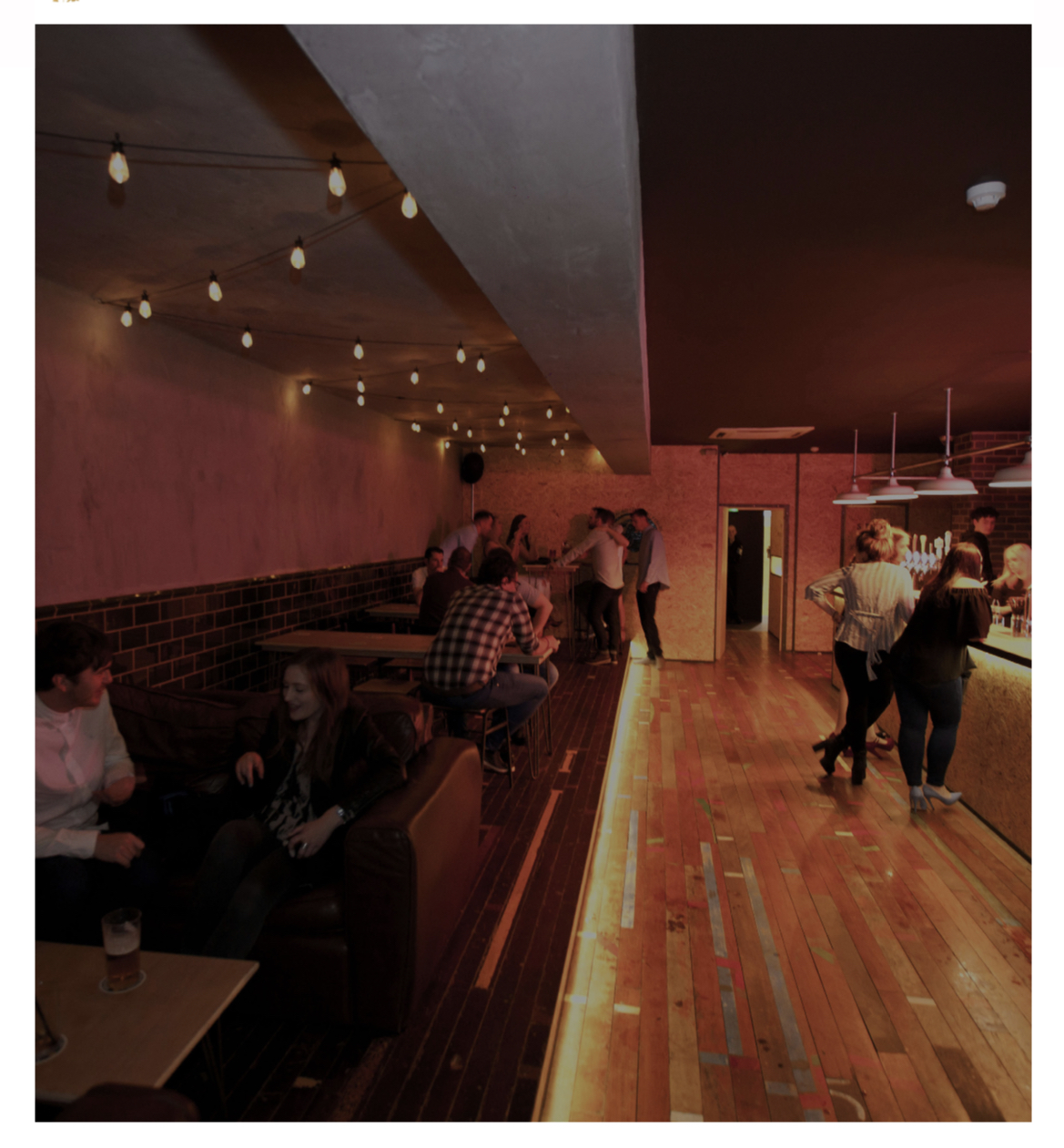 Vibrant event space with cozy lighting, perfect for networking and casual gatherings.