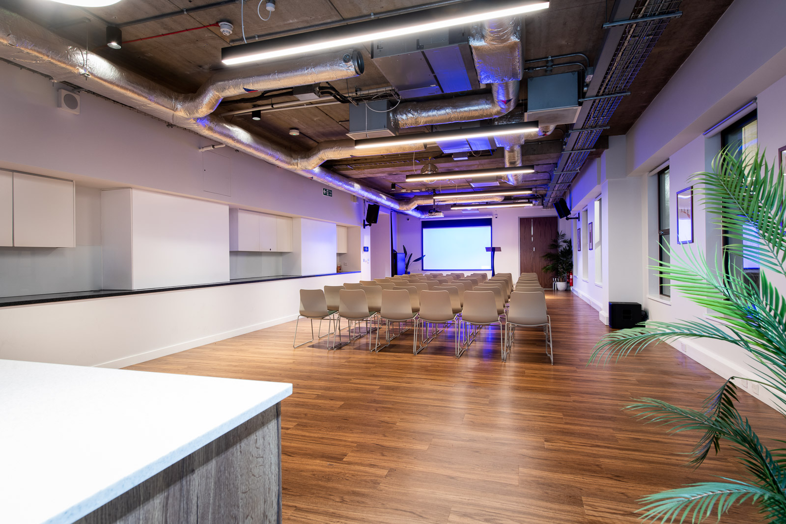 Modern event space with natural light, ideal for seminars and workshops.