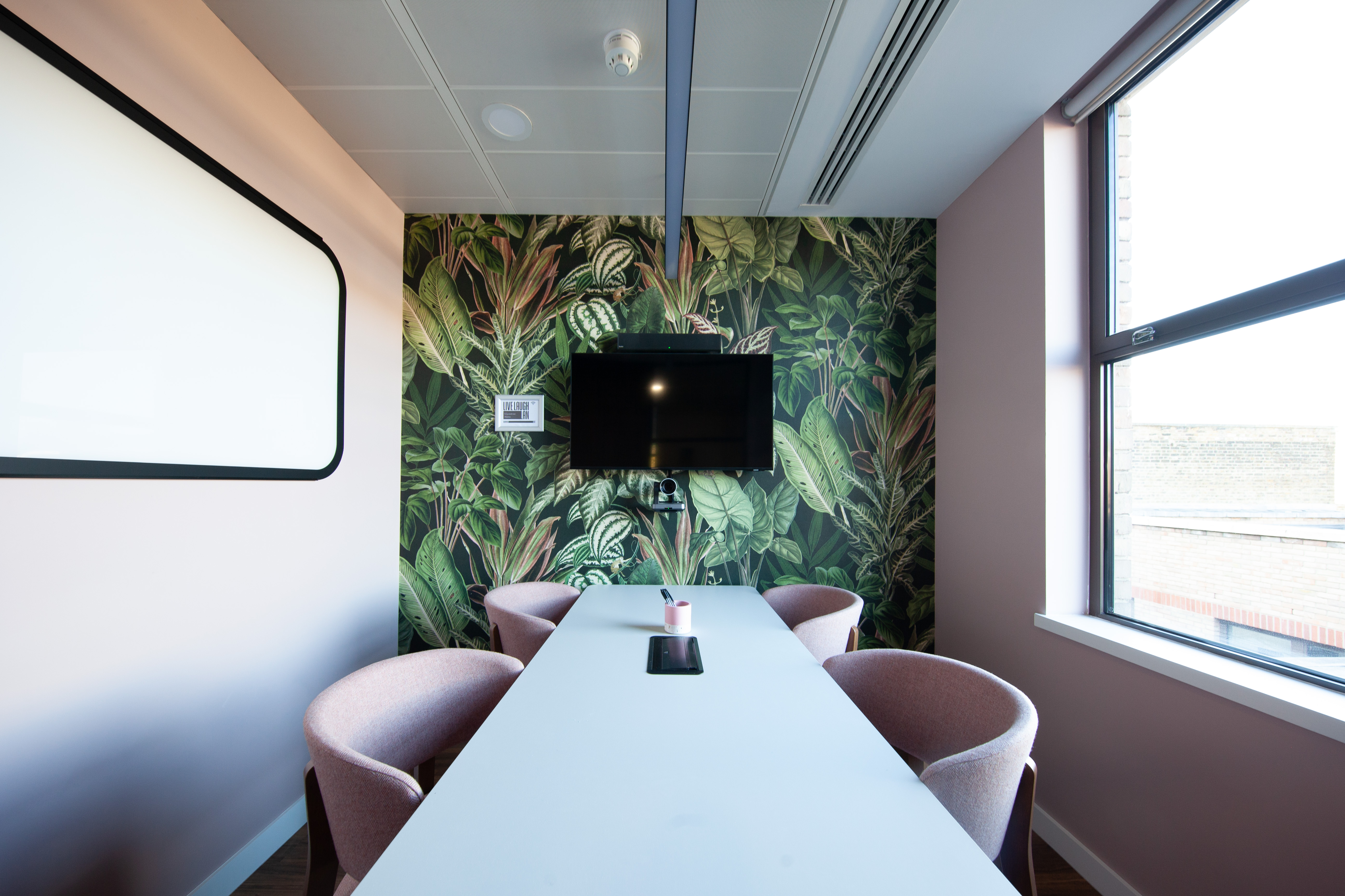 Modern meeting room at Runway East Bloomsbury with vibrant plant wallpaper for collaboration.
