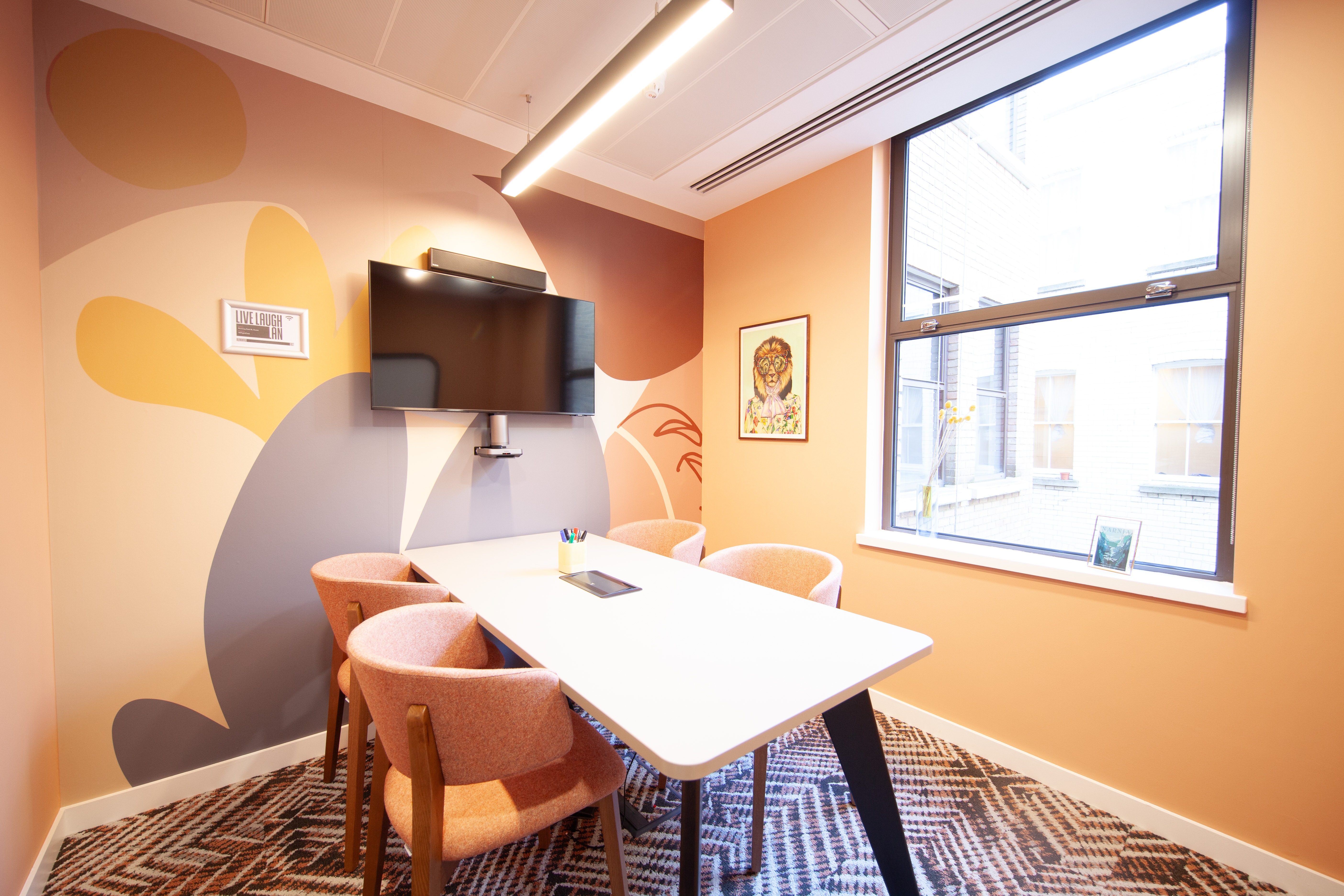 Modern meeting room in Runway East Bloomsbury with stylish table and vibrant wall art.