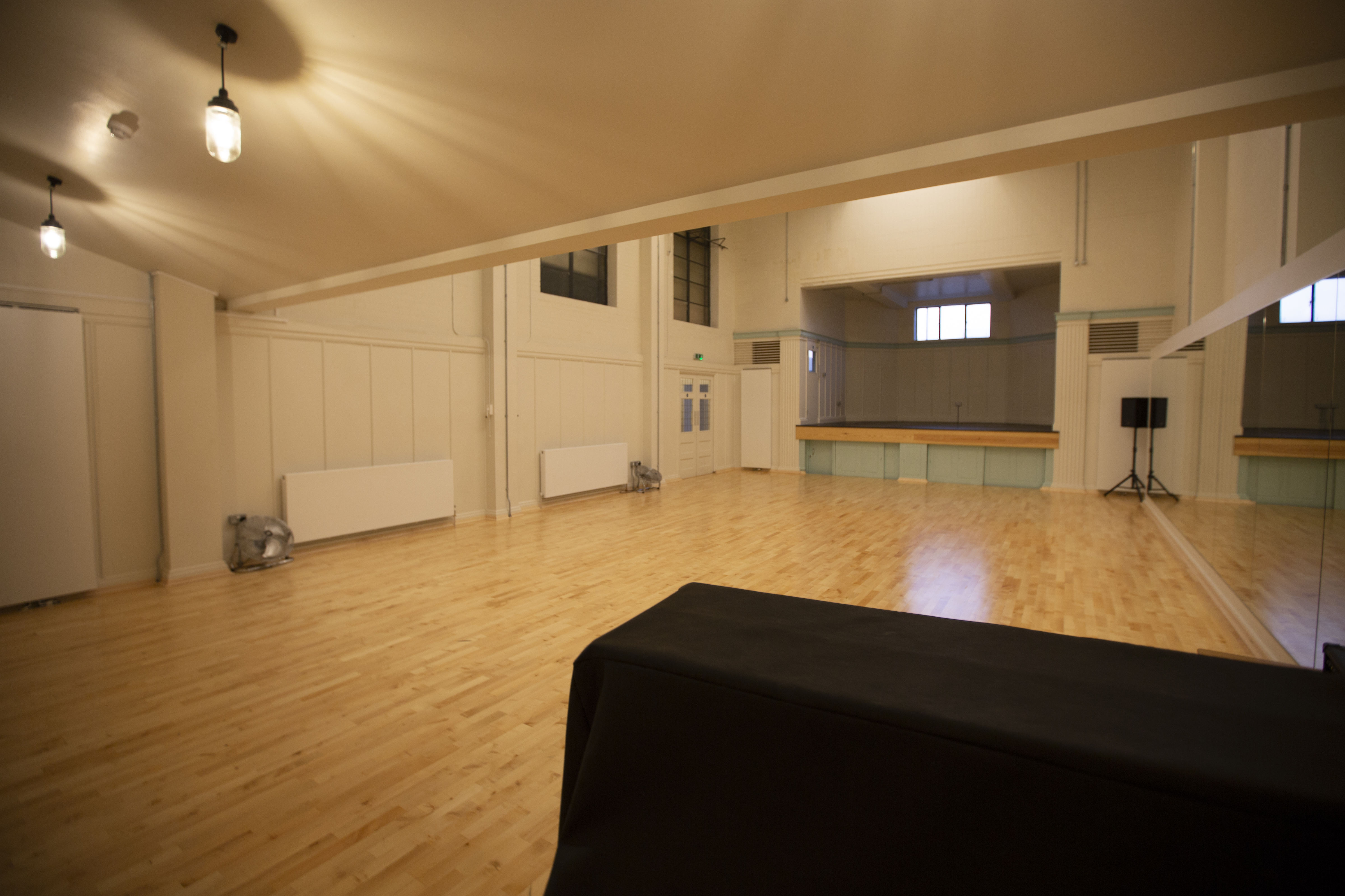 Versatile event space with polished wooden floors for workshops and meetings.