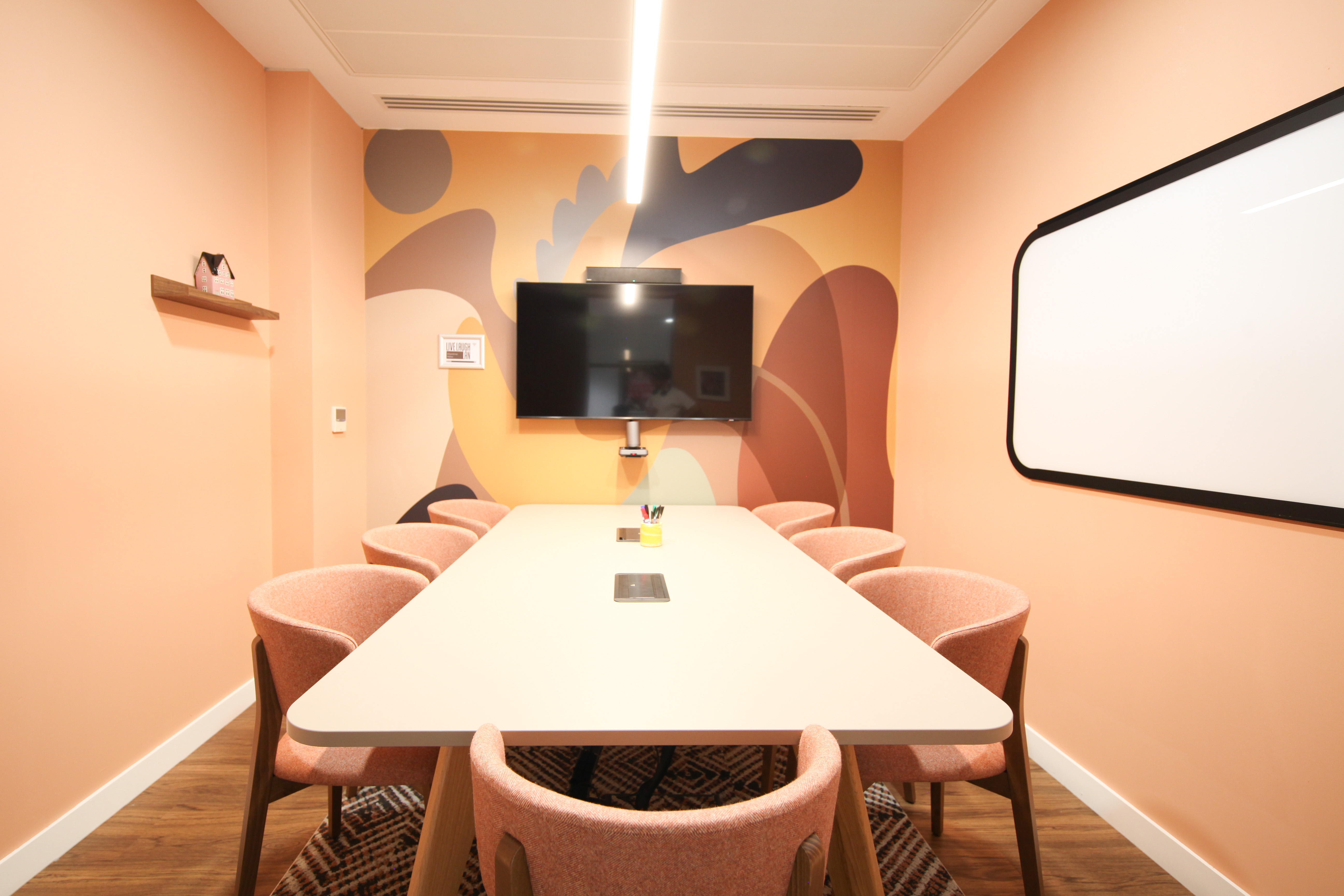 Modern meeting room in Runway East Bloomsbury with large table and vibrant wall art.