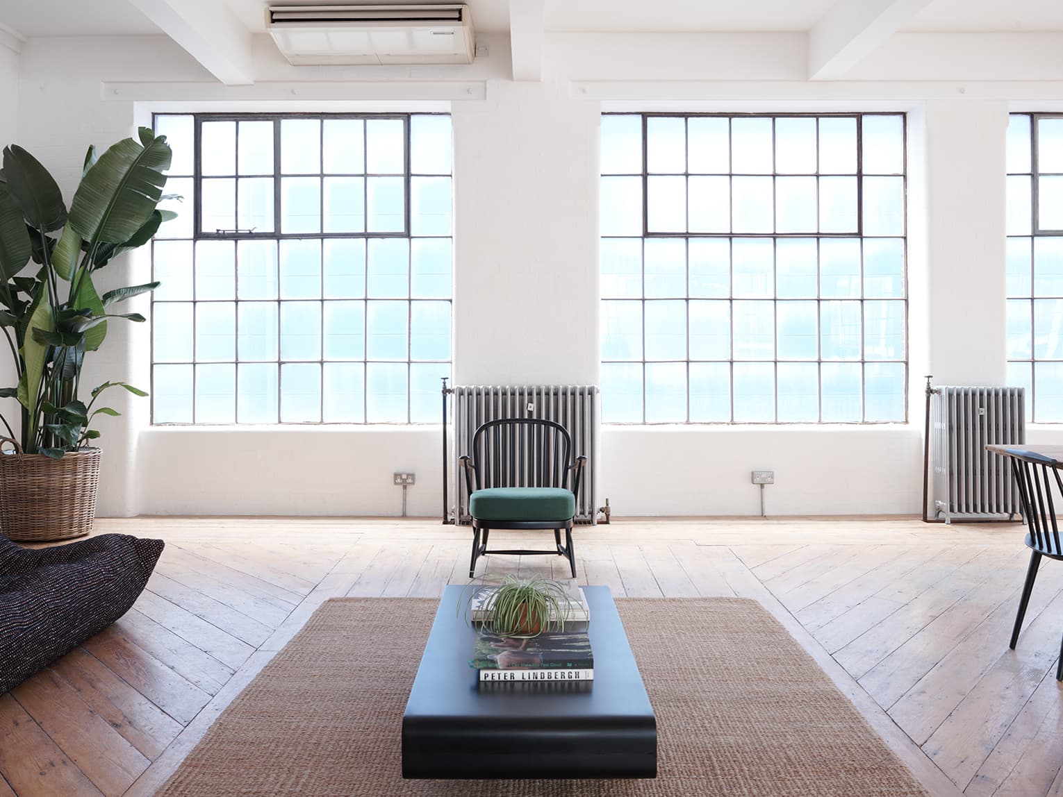 Studio 2 industrial VIP meeting room with floor-to-ceiling windows for creative workshops.