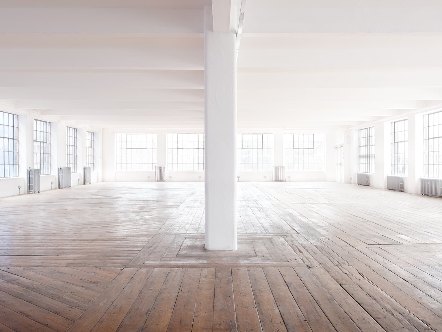 Studio 2 industrial blank canvas venue with hardwood floors for events and photoshoots.