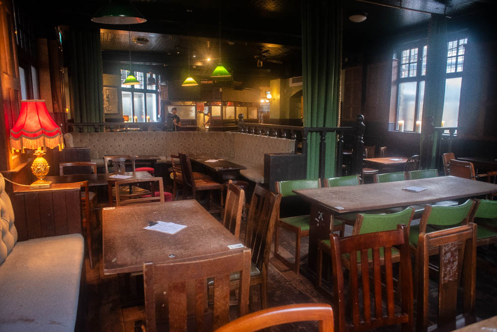 Cozy semi-private area with wooden seating for informal gatherings and events.