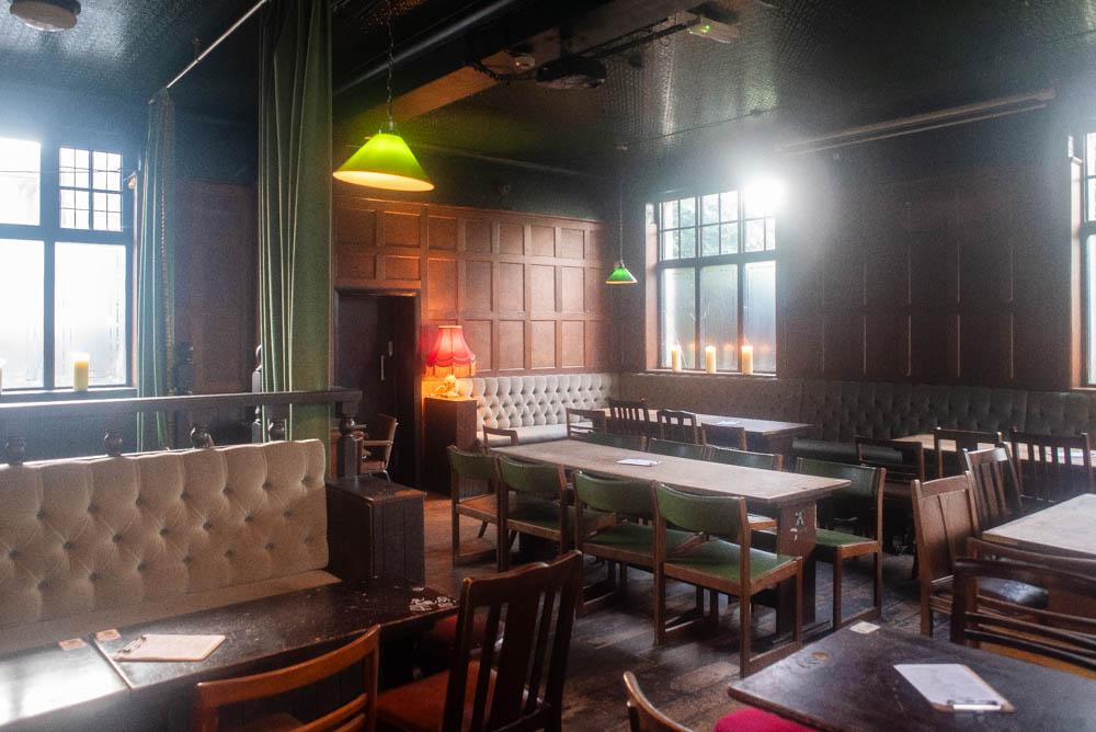 Semi-private event space with warm lighting for gatherings and meetings at The Adam & Eve.