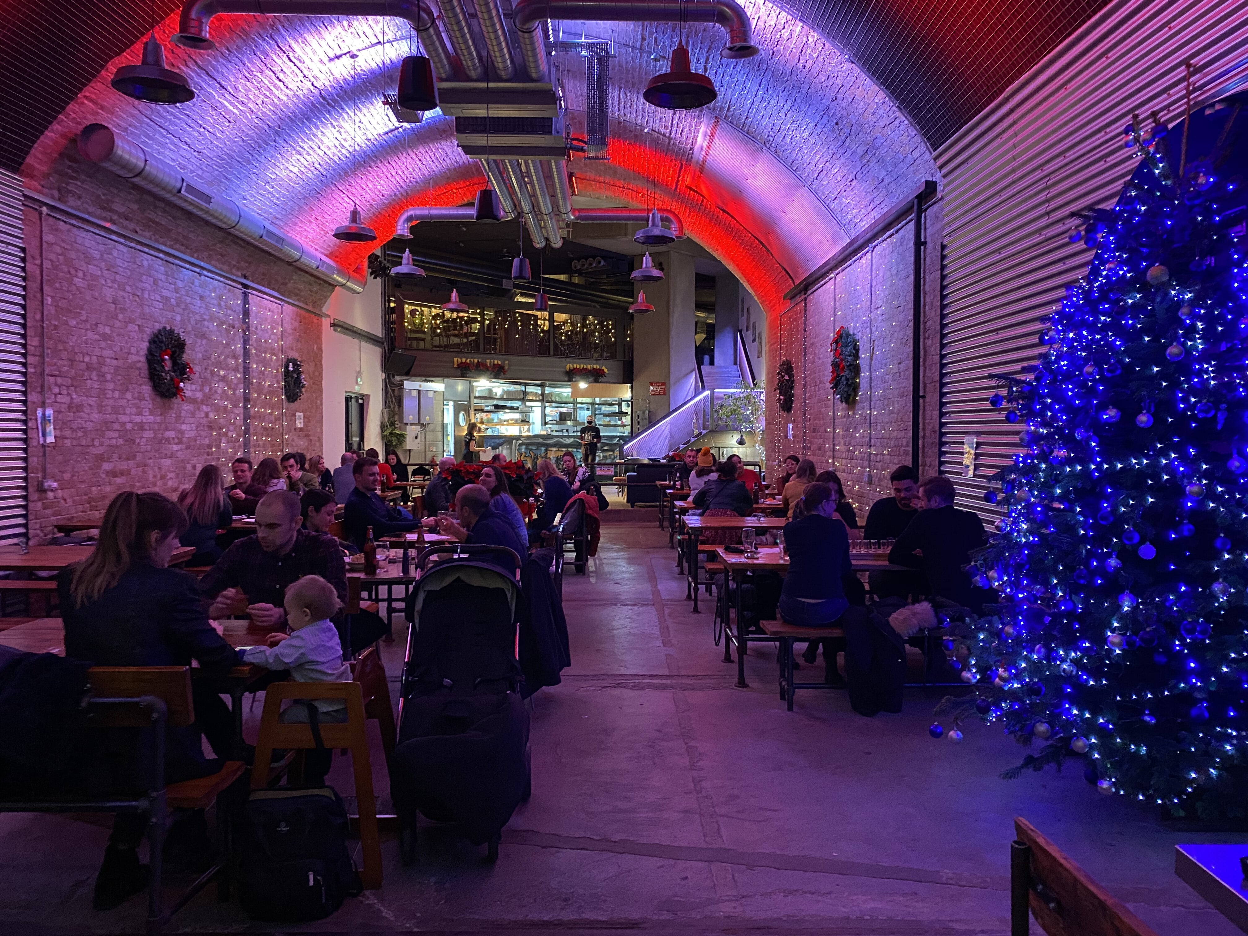 Vibrant event space with festive decor at The Old Arch, perfect for holiday gatherings.