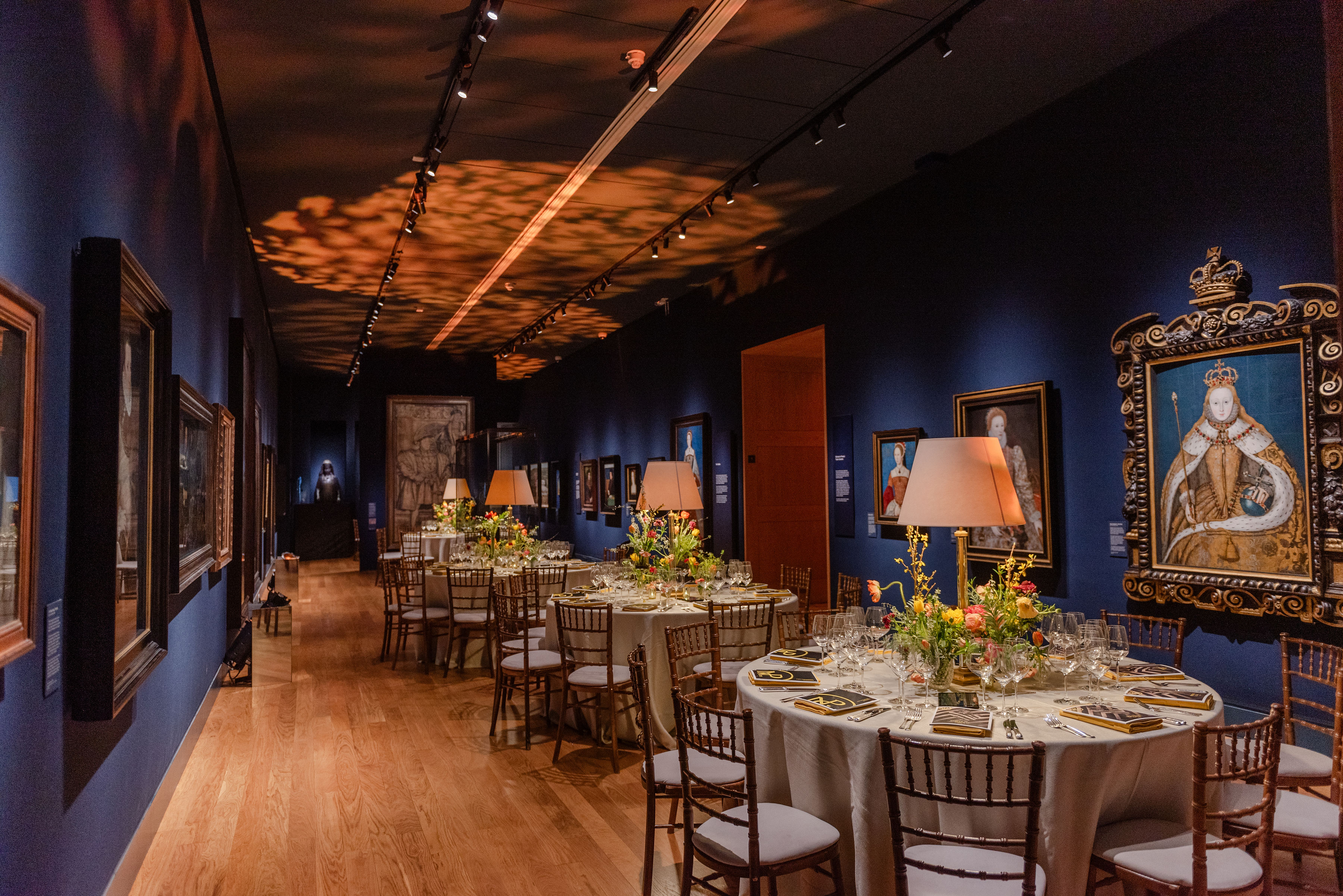 Elegant Tudor Galleries event space with floral centerpieces, ideal for corporate gatherings.