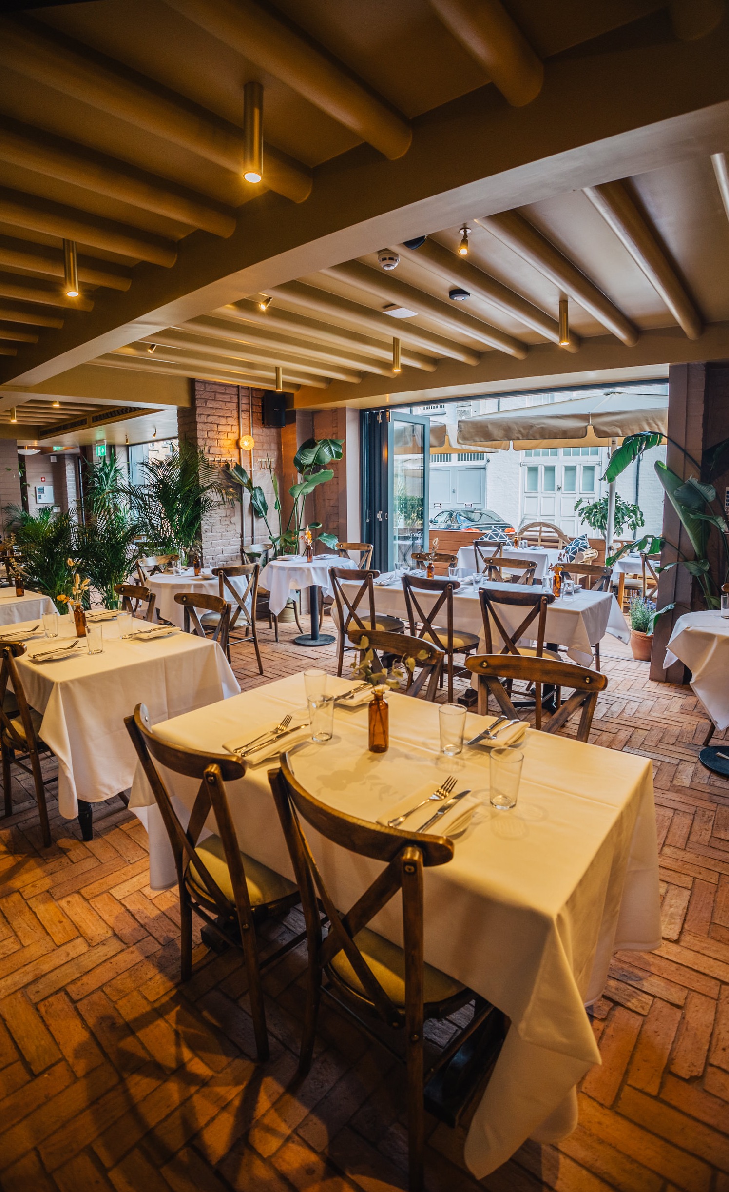 Elegant dining space in LULA with white linens, perfect for corporate events and gatherings.