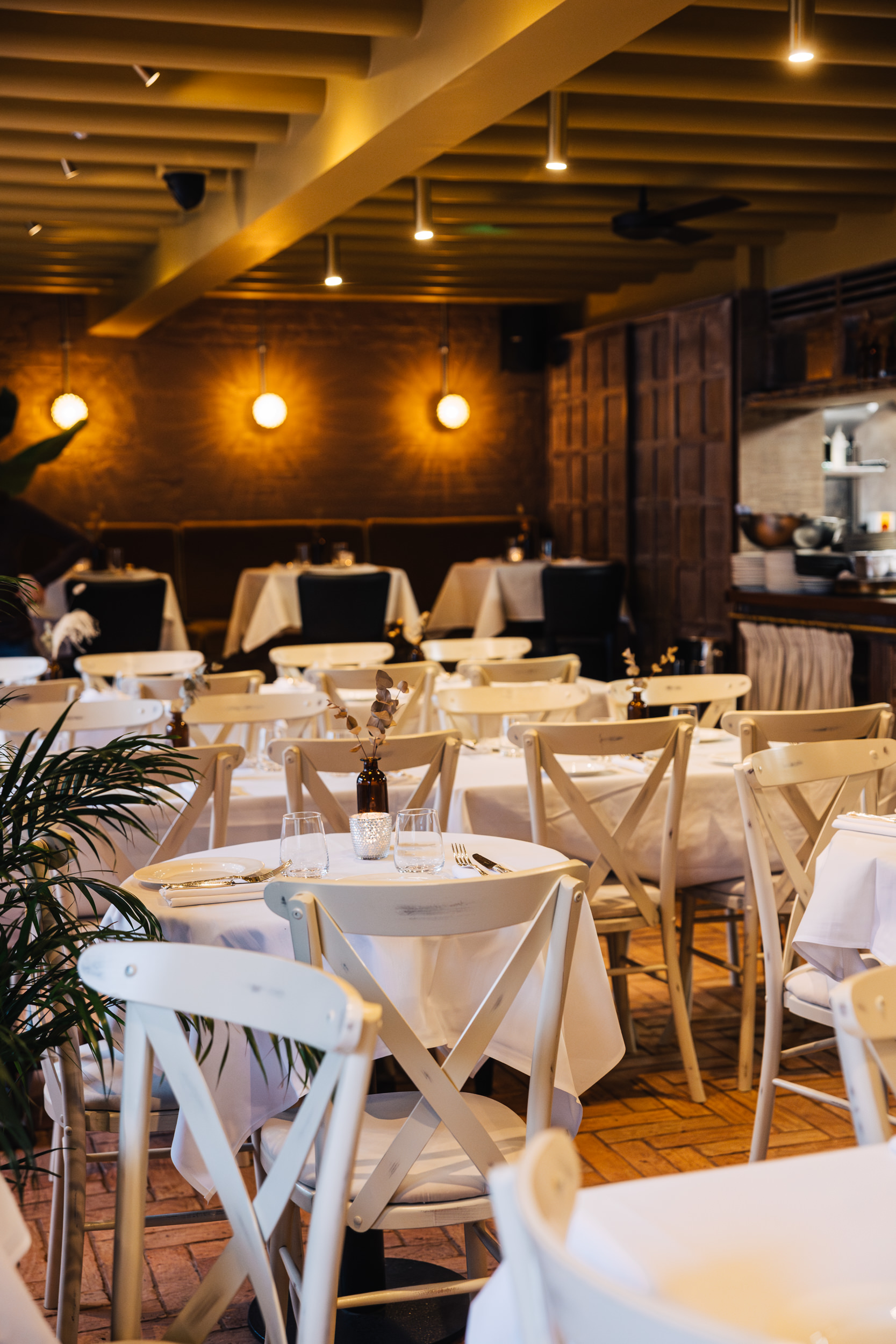 Elegant dining space in LULA with white linens, perfect for events and gatherings.