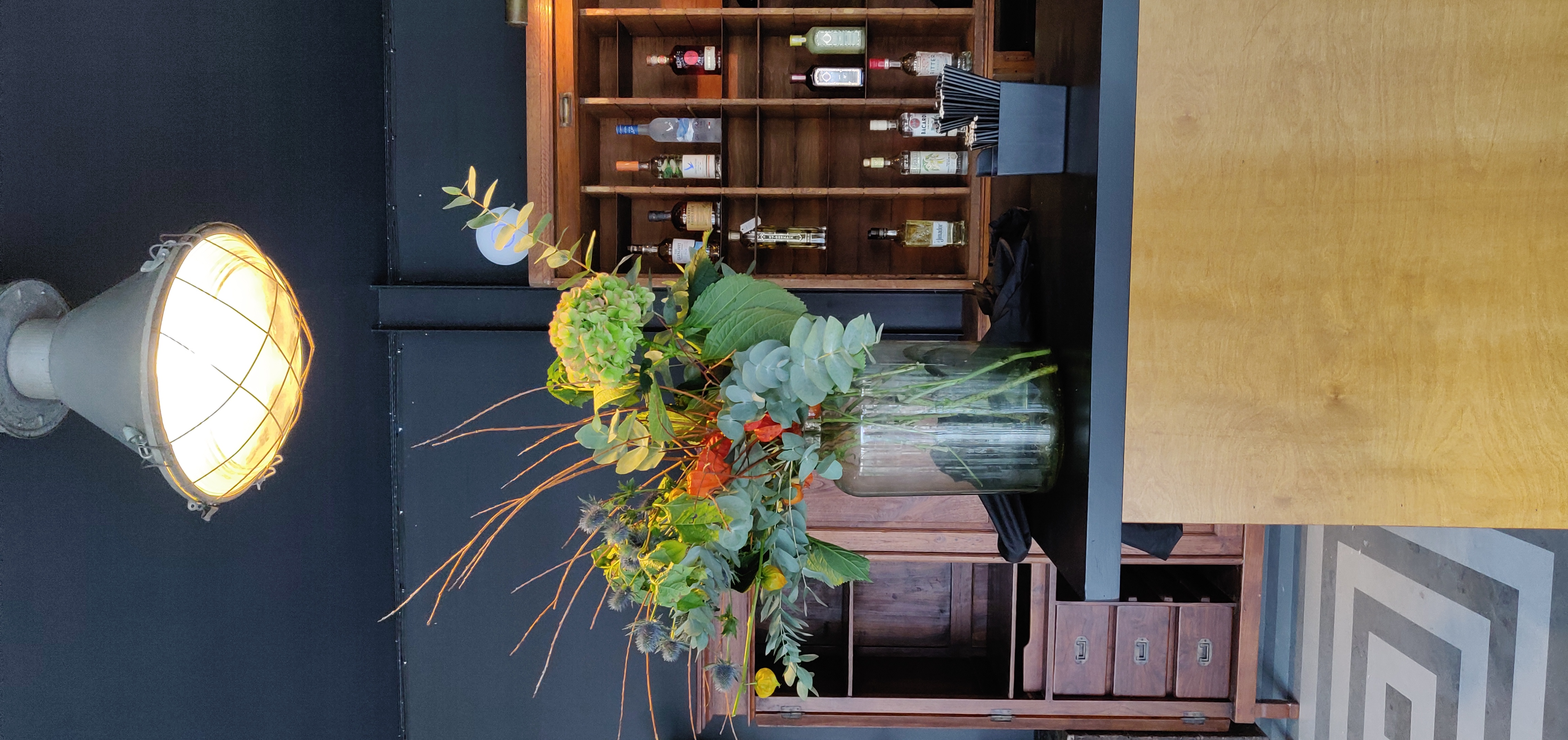 Stylish event setup at Nico's Bar, featuring vibrant floral arrangement in Hackney Bridge.