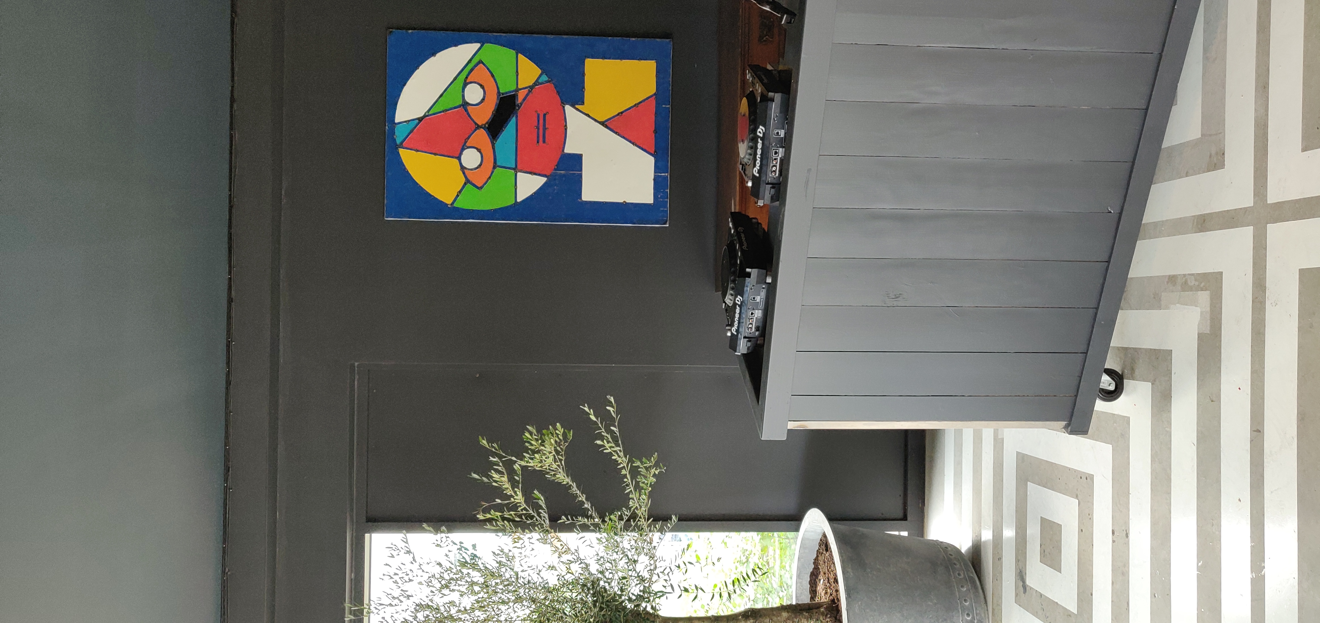 Nico's Bar in Hackney Bridge: modern event space with DJ setup and vibrant artwork.