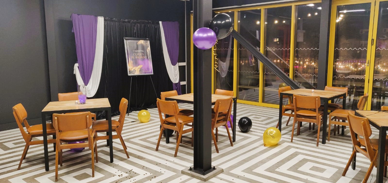 Stylish event space in Hackney Bridge with striped floor, ideal for meetings and celebrations.