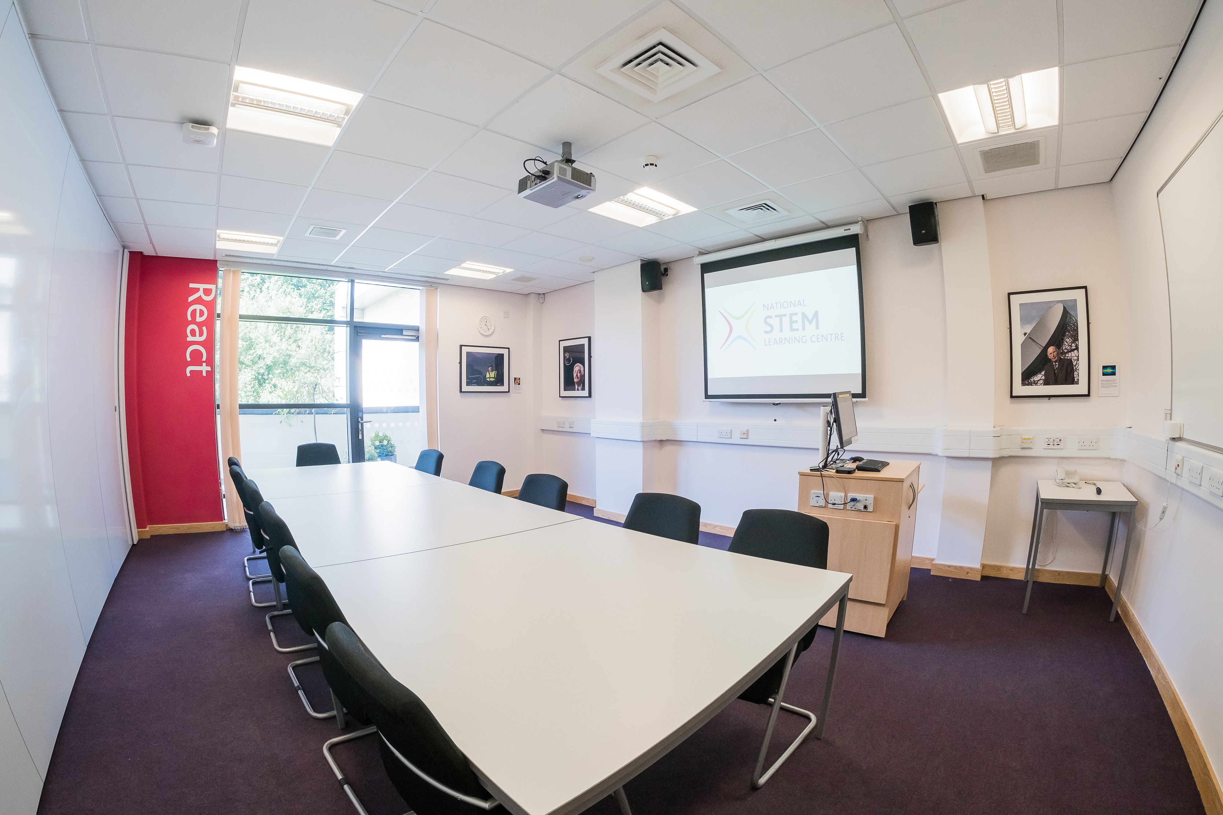 Seminar room with modern table and ergonomic chairs for workshops at National STEM Learning Centre.
