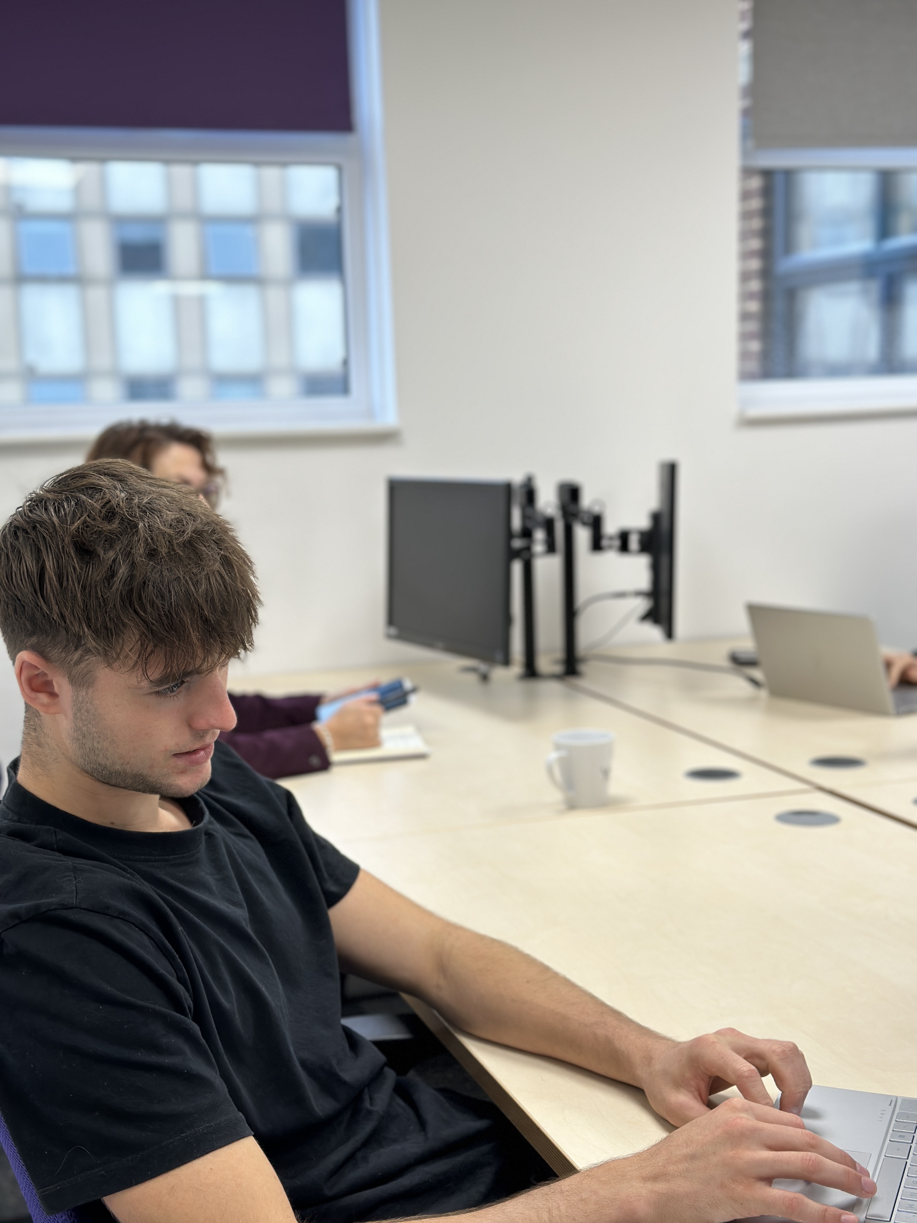 Modern meeting space with engaged participants and tech setup for collaboration.