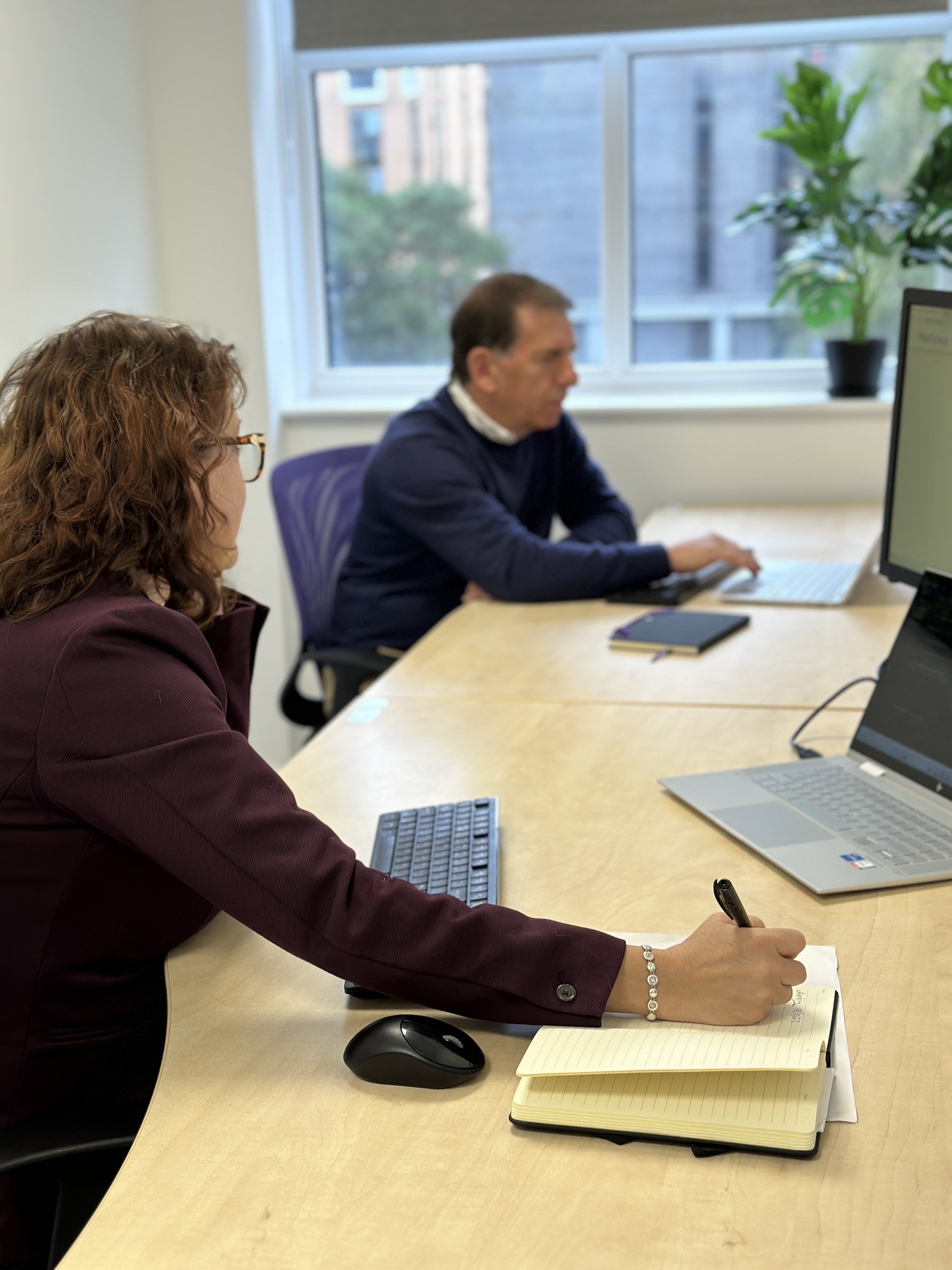 Focused meeting with professionals collaborating in a bright, creative environment.
