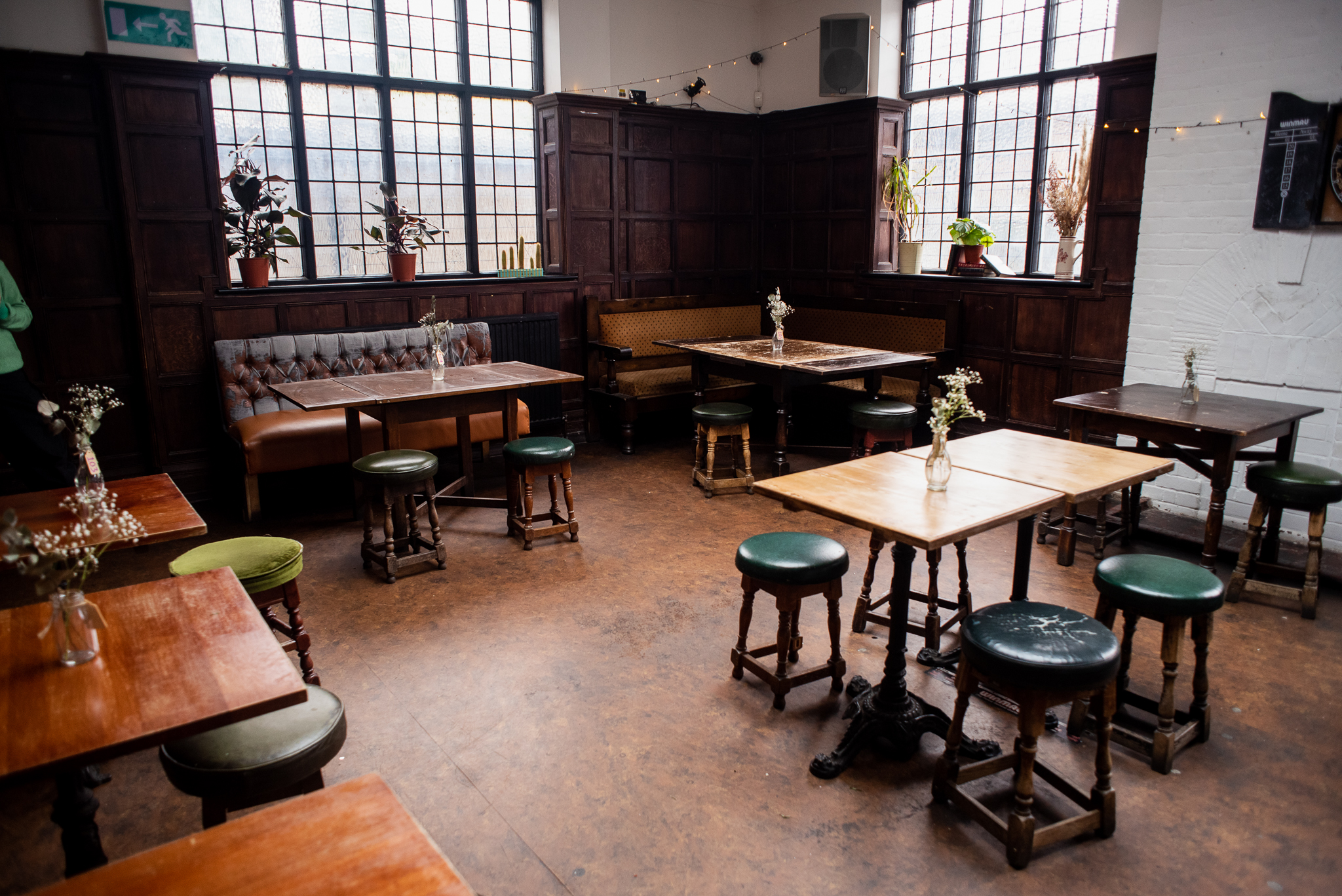 Cozy Games Room in Beehive with wooden tables, ideal for gatherings and meetings.
