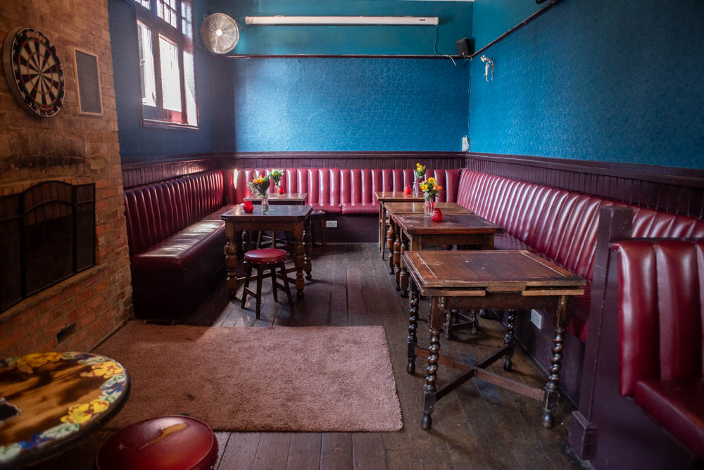 Cozy Function Room at The Chequers with blue walls, ideal for meetings and team-building.