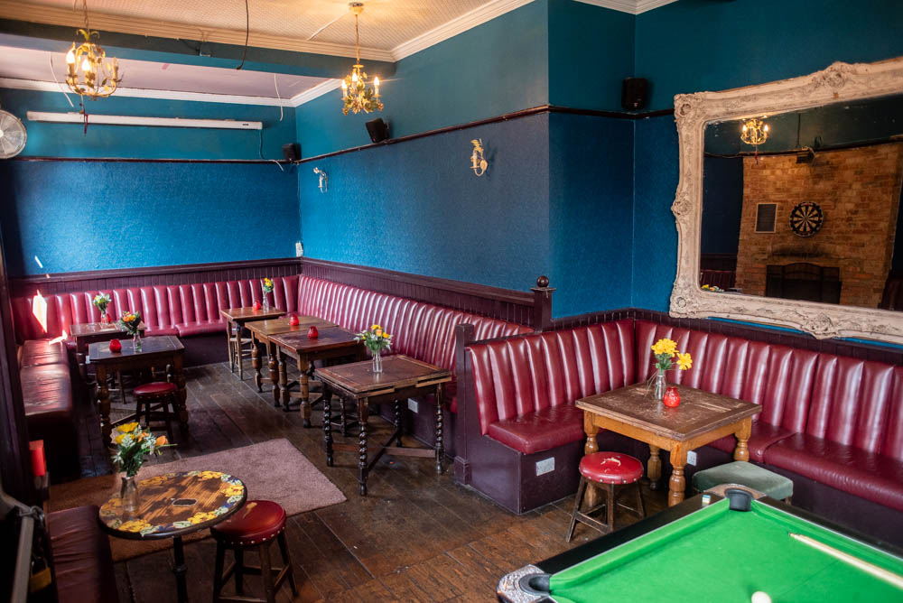 Cozy Function Room at The Chequers with blue walls, ideal for networking events.